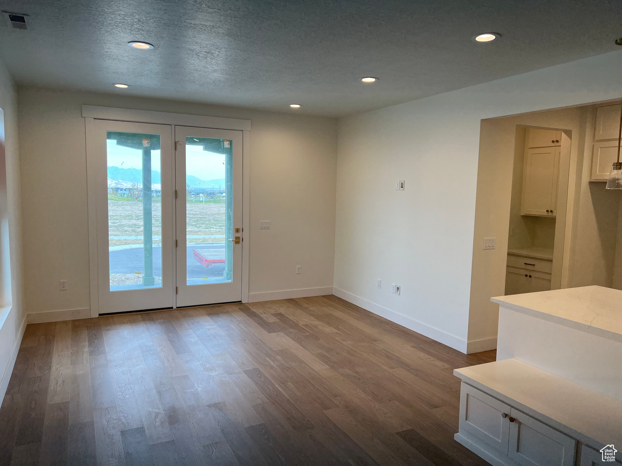 Empty room featuring a textured ceiling and hardwood / wood-style flooring