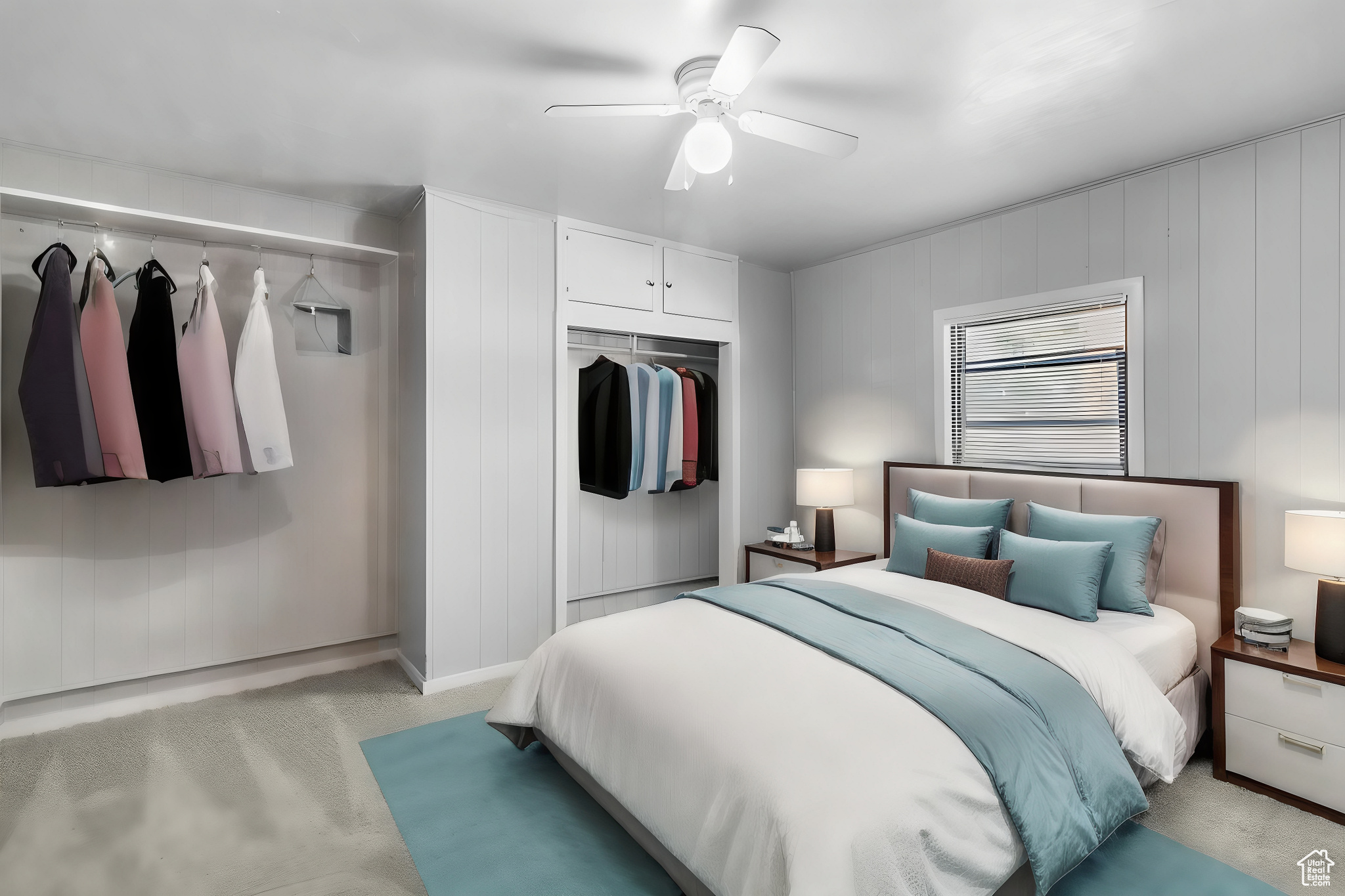 Bedroom with light colored carpet, a closet, and ceiling fan