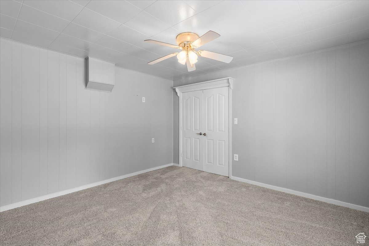 Spare room with carpet and ceiling fan