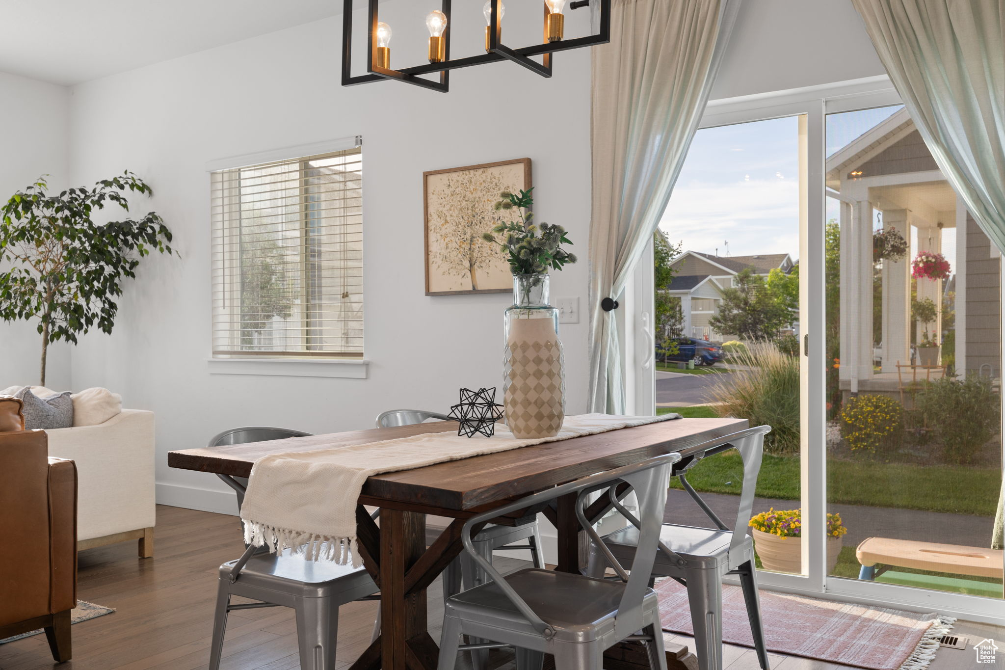 Dining area featuring an inviting chandelier and hardwood / wood-style floors