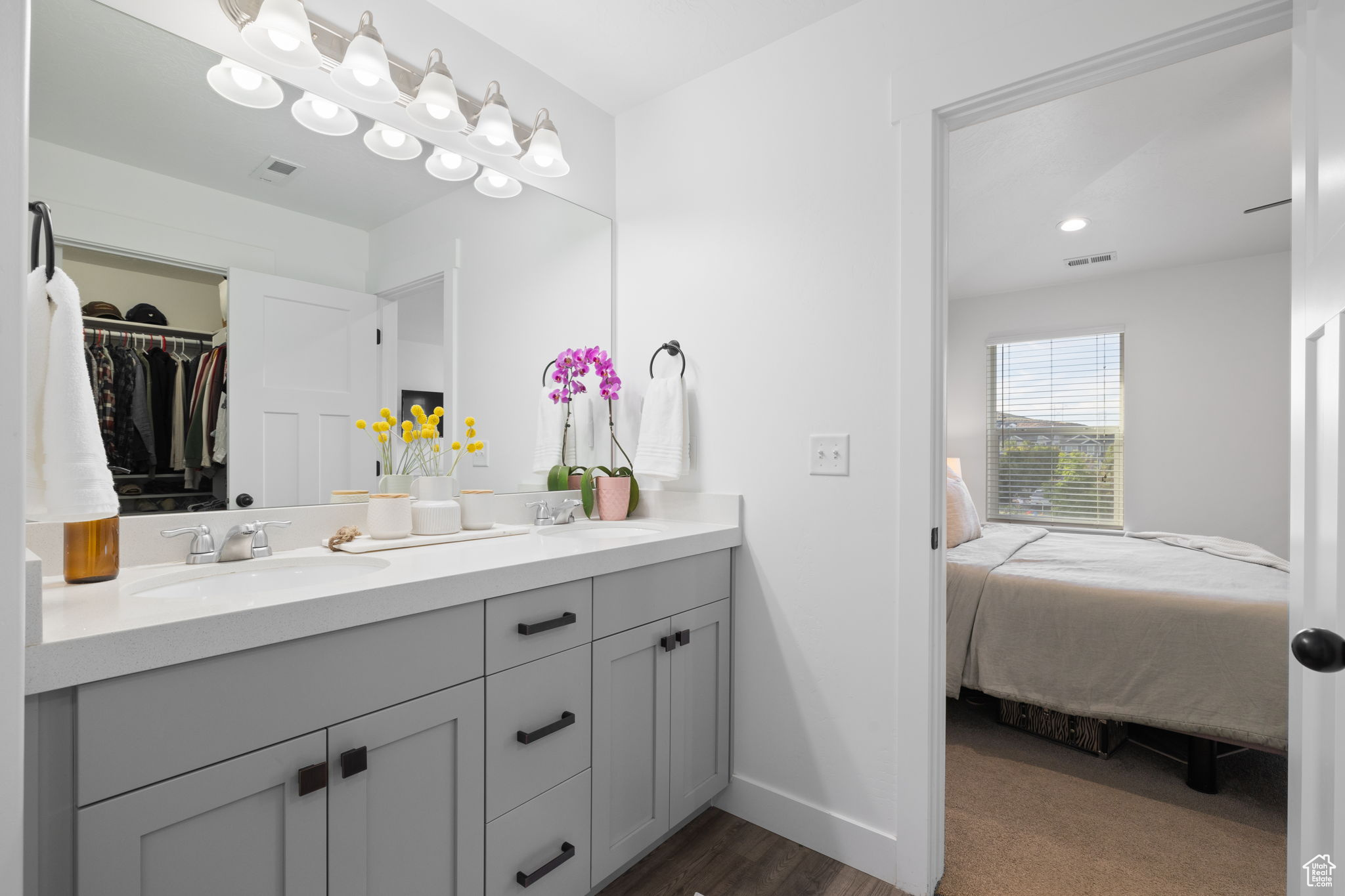 Bathroom featuring dual vanity and hardwood / wood-style floors