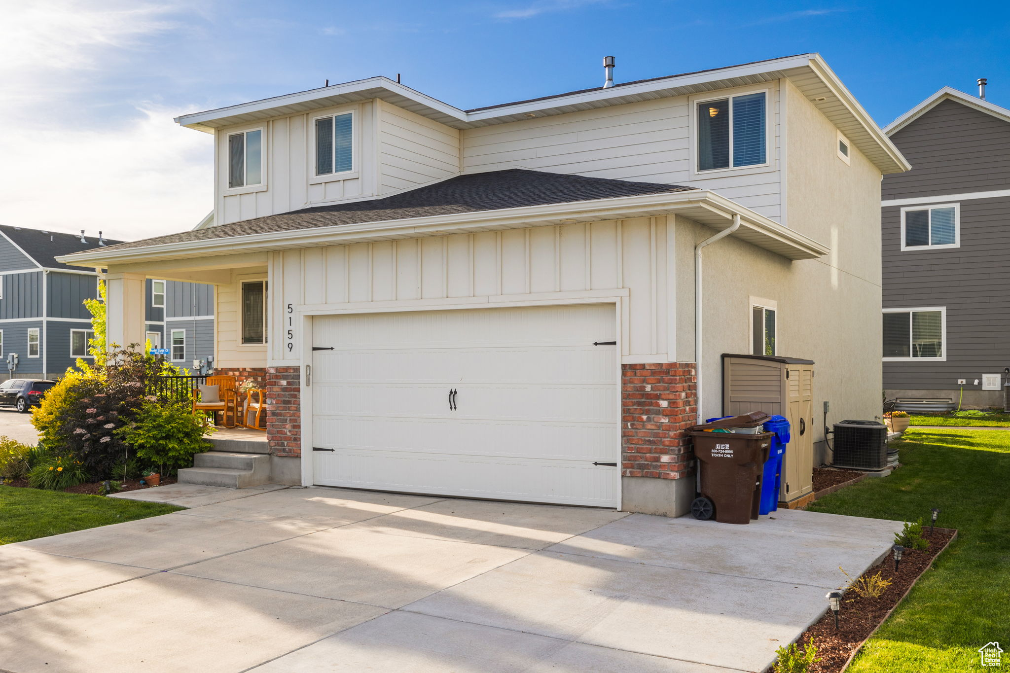 View of front of property featuring a garage and central AC