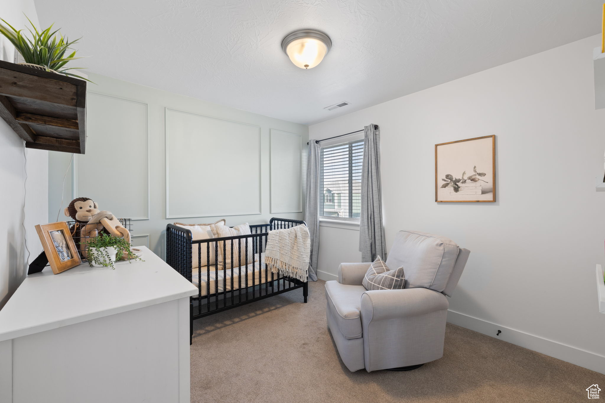 Carpeted bedroom with a crib