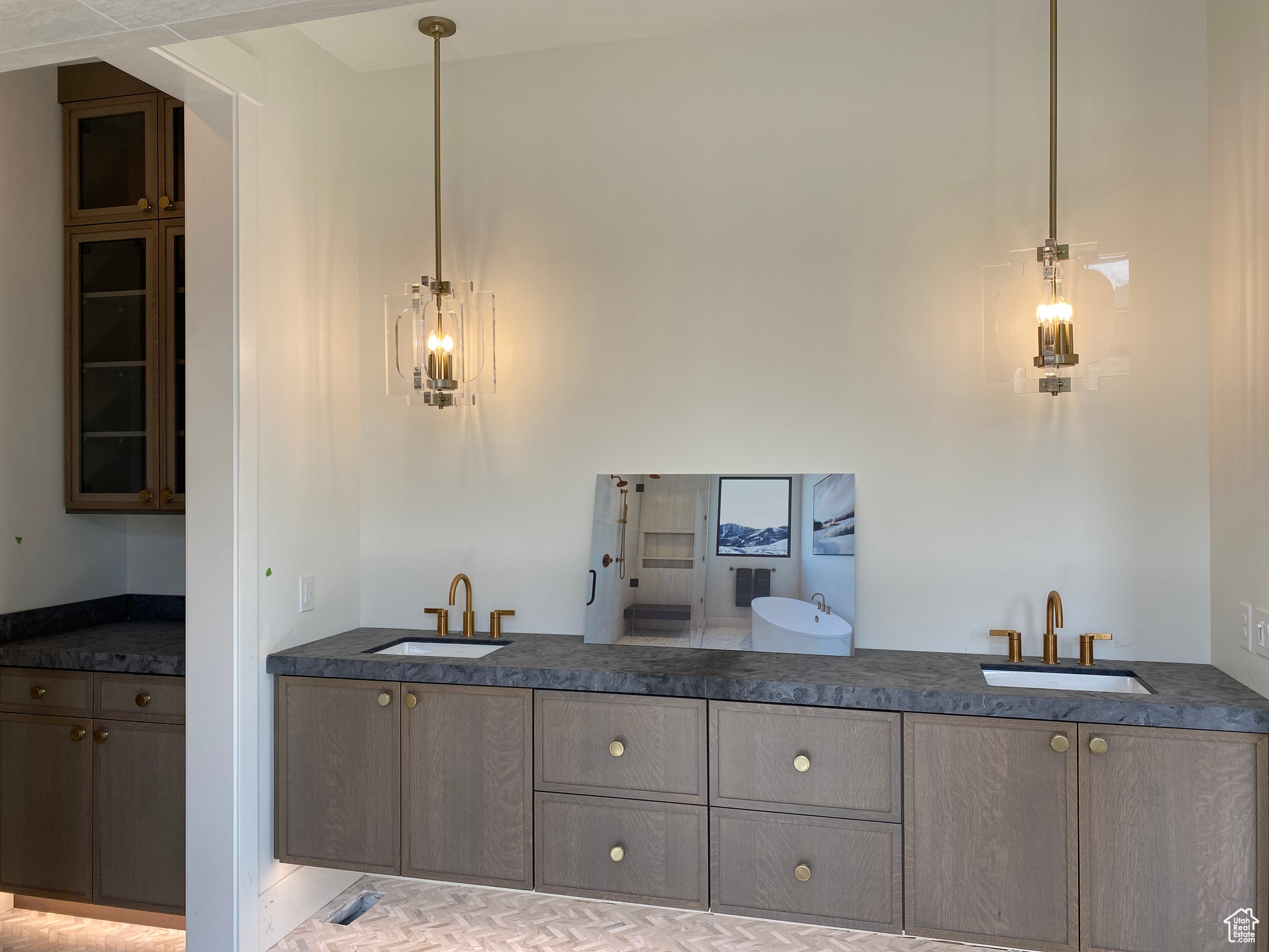 Kitchen with light tile patterned floors, sink, and pendant lighting