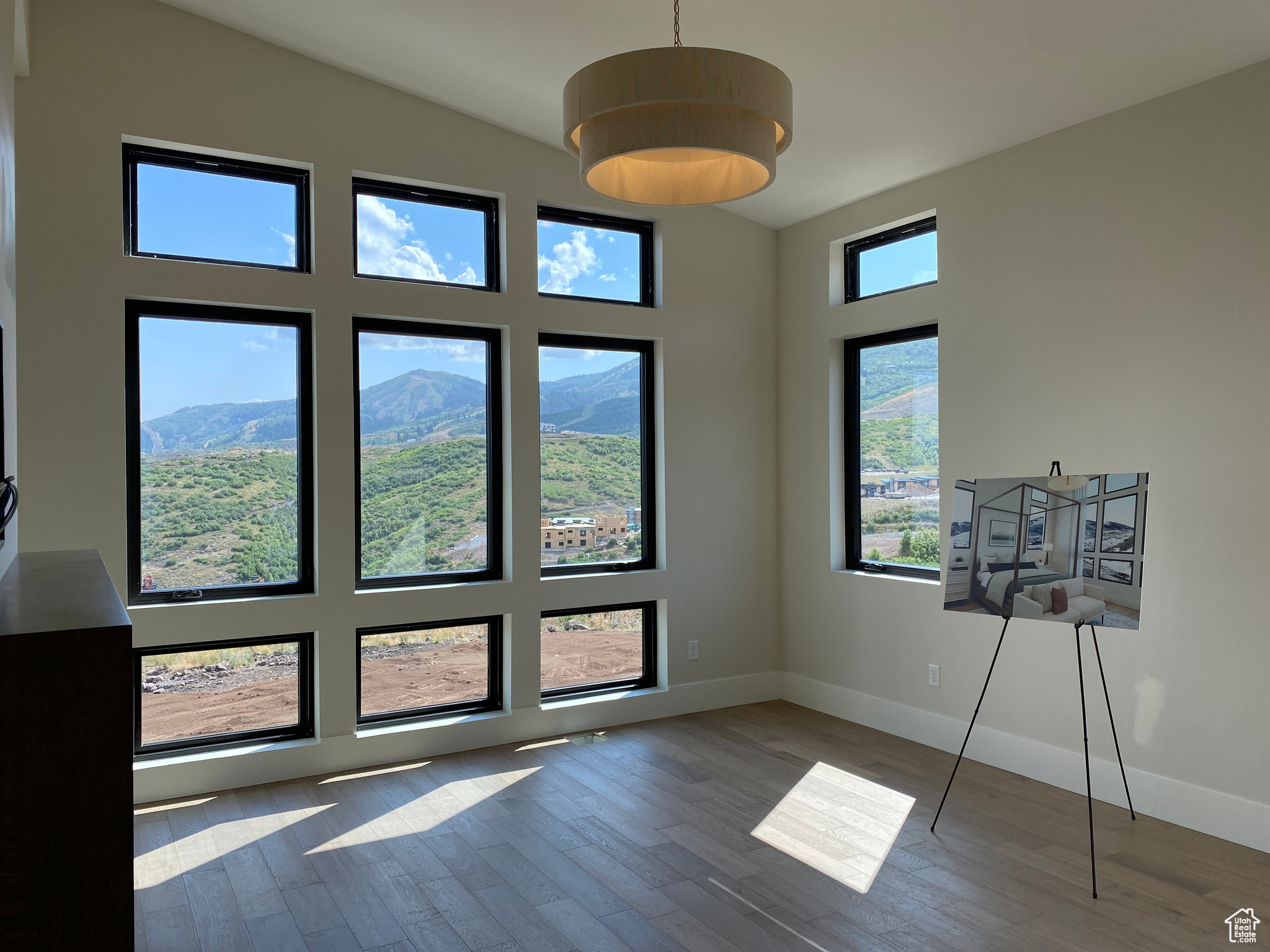 Interior space featuring plenty of natural light, a mountain view, lofted ceiling, and light hardwood / wood-style flooring