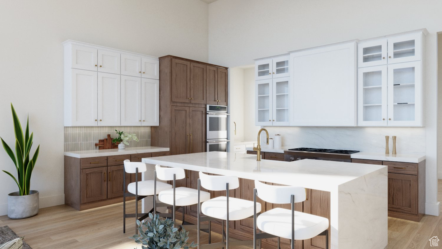 Kitchen featuring white cabinetry, light hardwood / wood-style floors, a center island with sink, double oven, and a towering ceiling