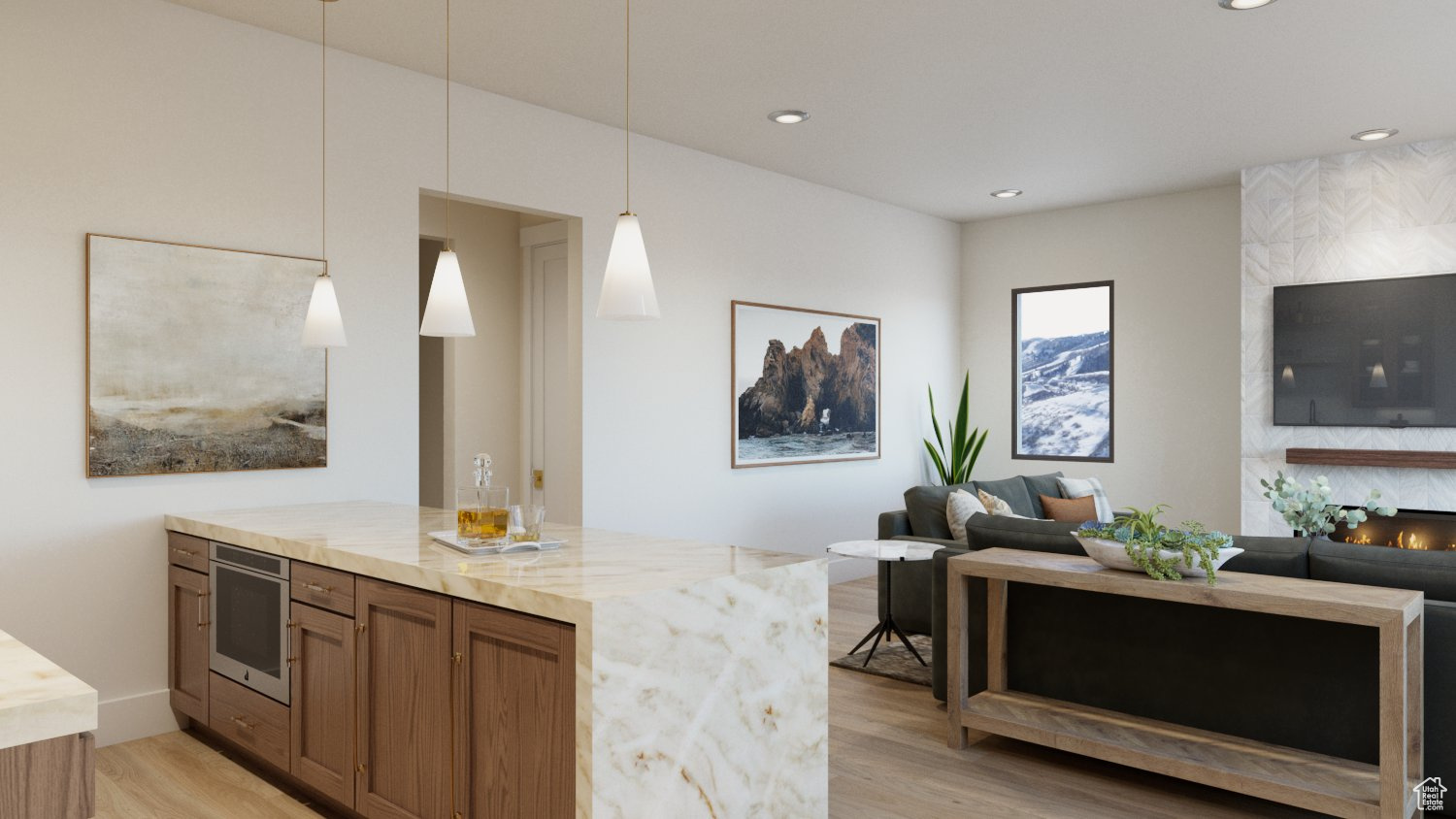 Bar with light stone countertops, light hardwood / wood-style flooring, a large fireplace, and decorative light fixtures