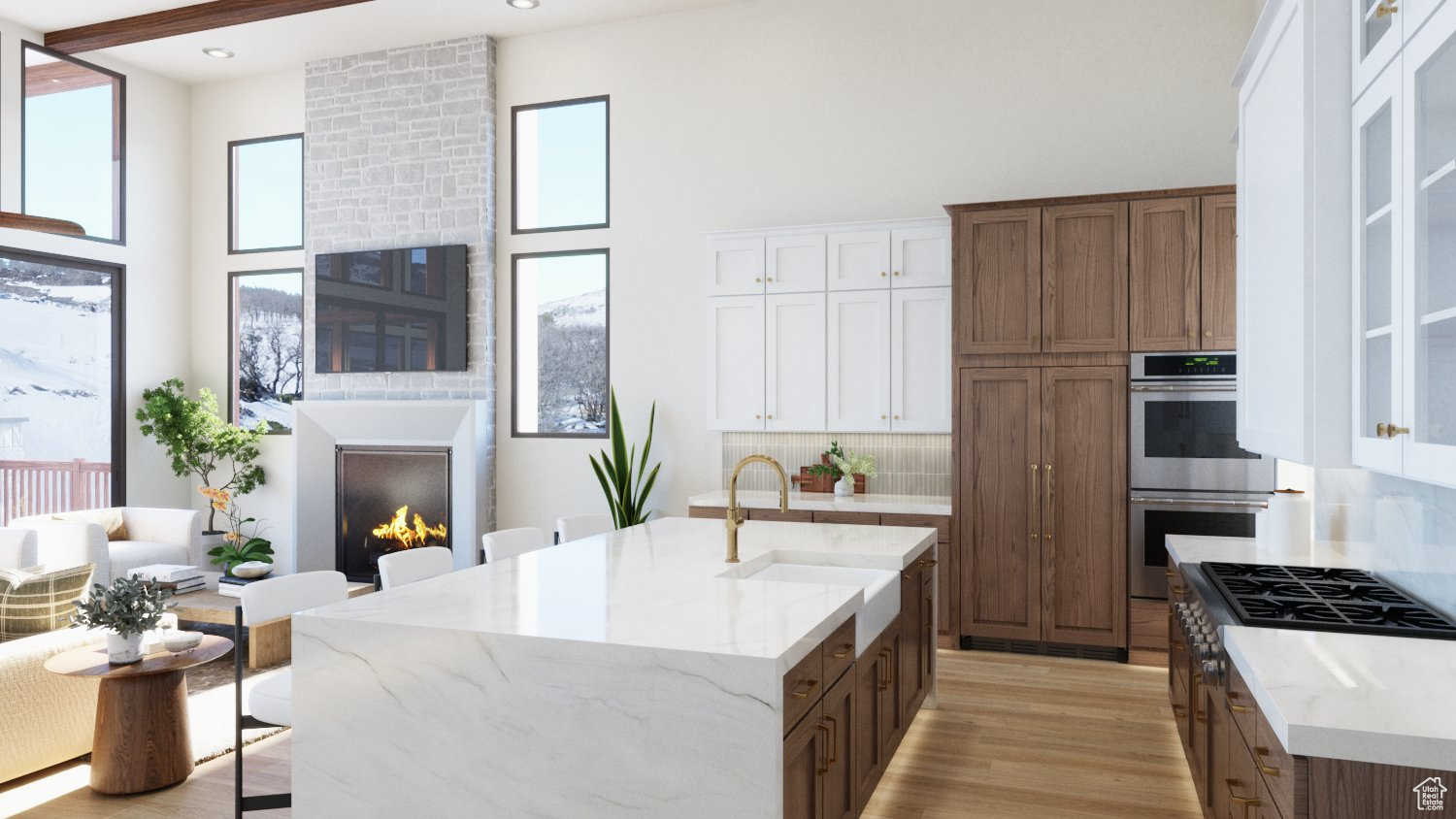 Kitchen featuring white cabinets, plenty of natural light, a large fireplace, and light hardwood / wood-style floors