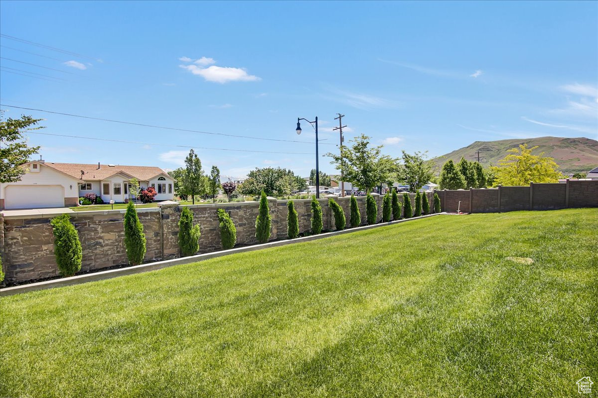 View of yard featuring a garage and a mountain view