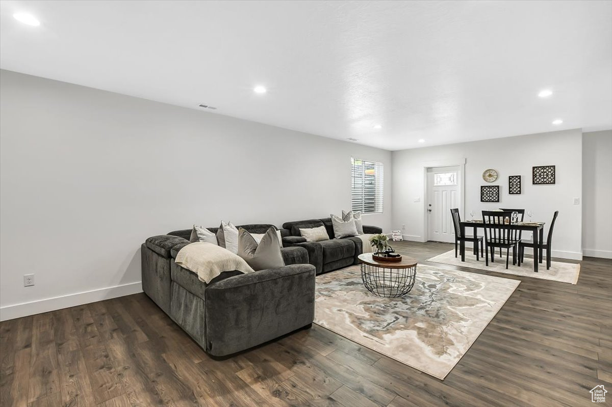 Living room with dark hardwood / wood-style floors