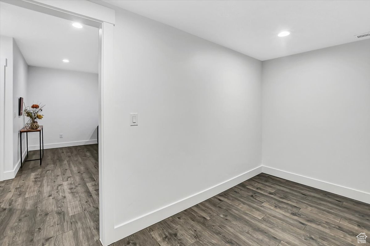 Spare room with dark hardwood / wood-style flooring