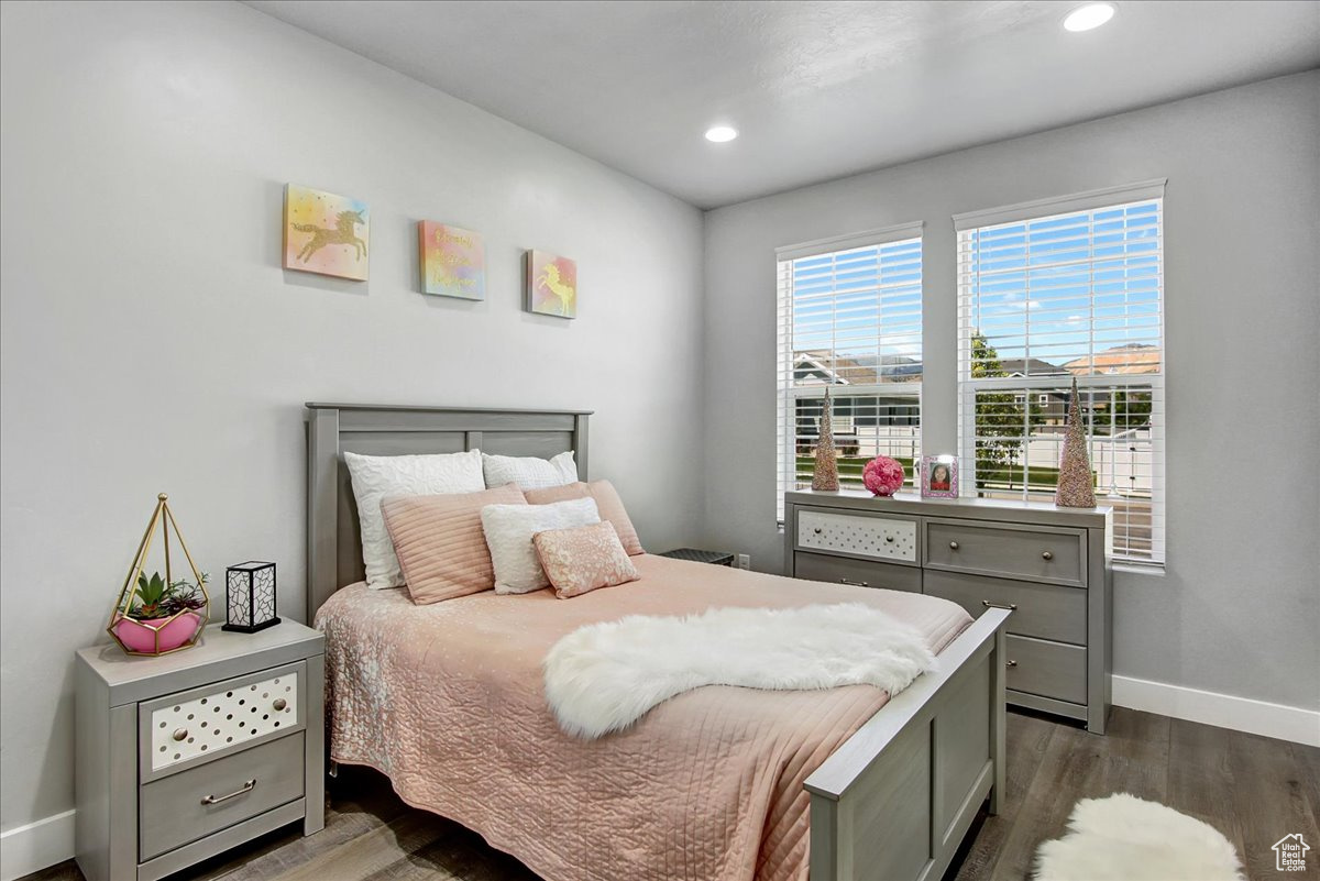 Bedroom with dark hardwood / wood-style floors