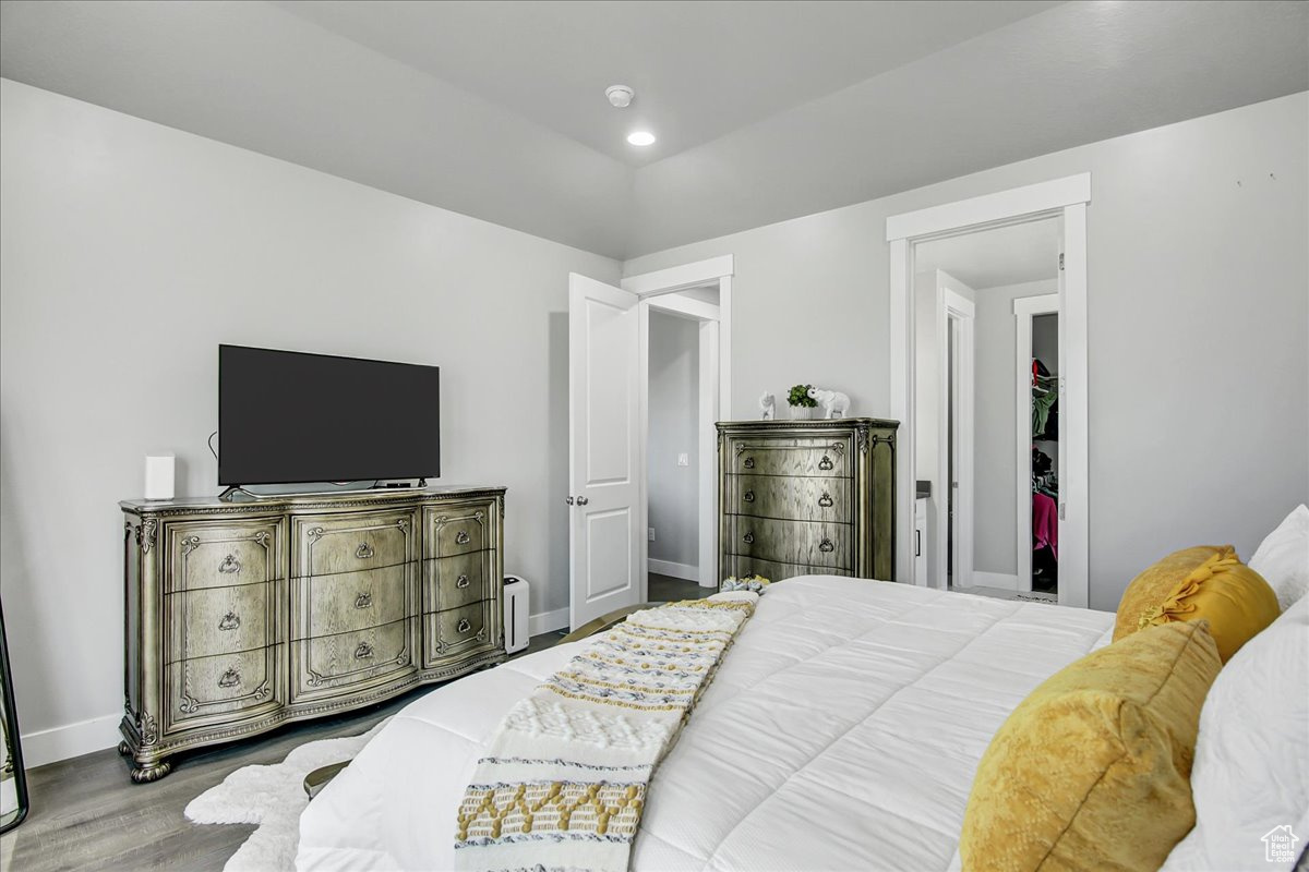 Bedroom with wood-type flooring and a closet