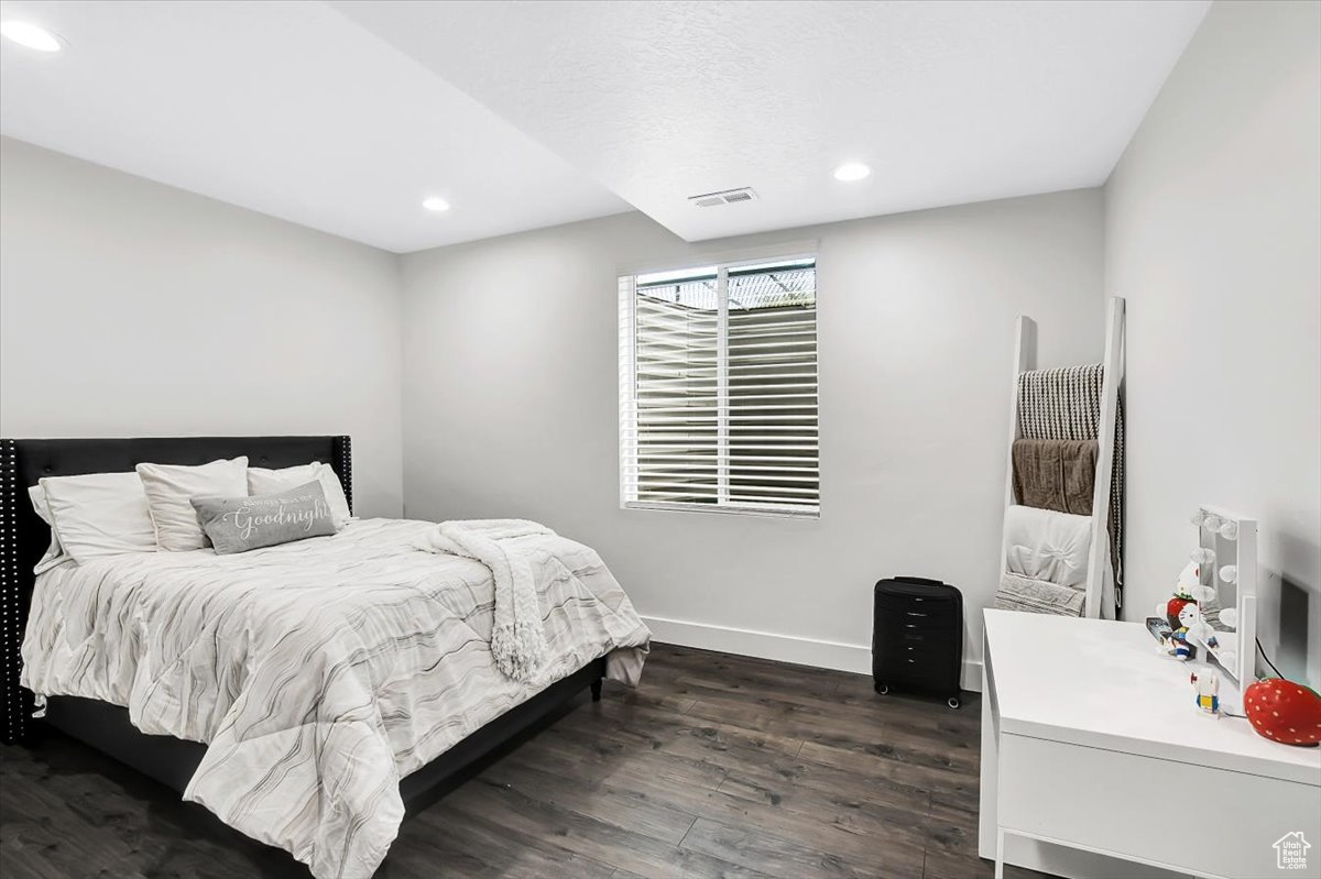 Bedroom with dark wood-type flooring