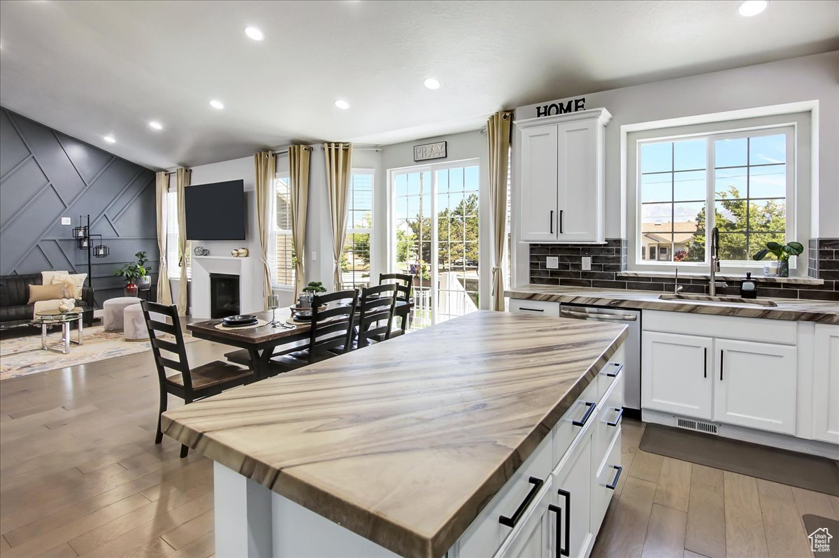 Kitchen featuring a healthy amount of sunlight, backsplash, and a kitchen island