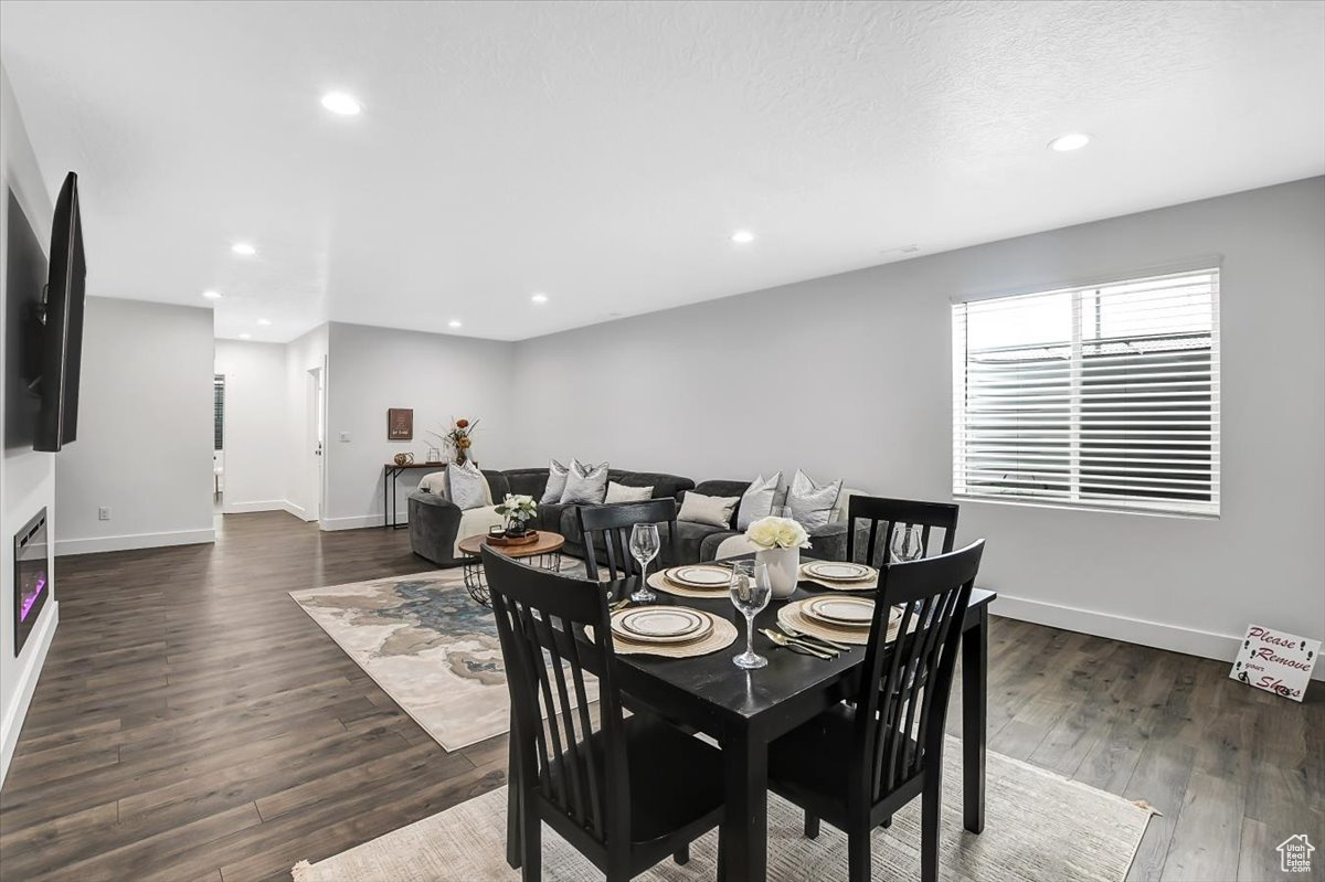 Dining room with dark hardwood / wood-style flooring