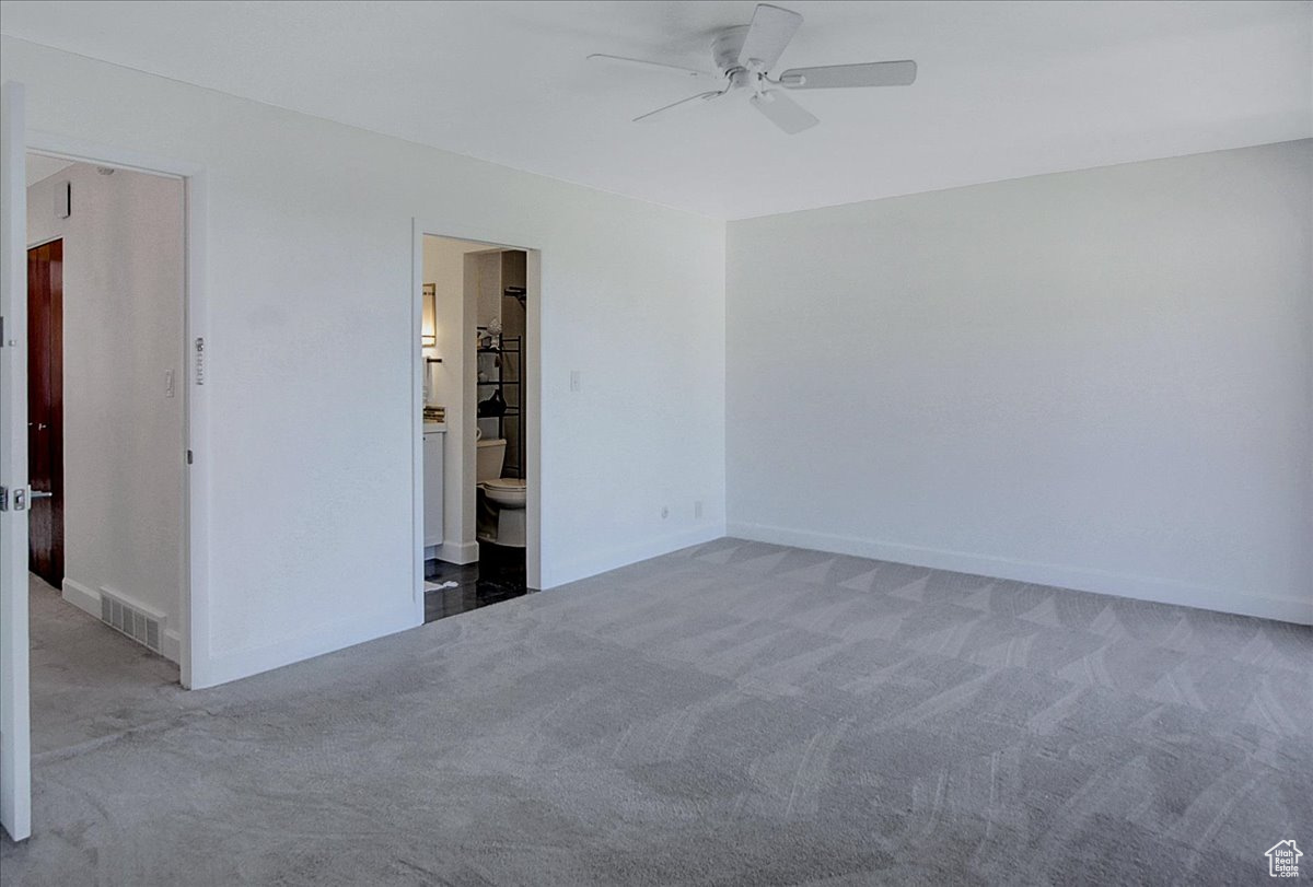 Empty room featuring carpet floors and ceiling fan