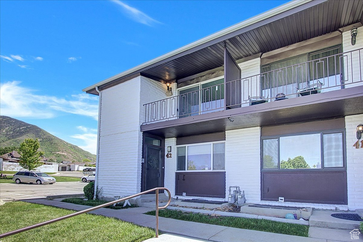 View of front facade with a mountain view and a balcony