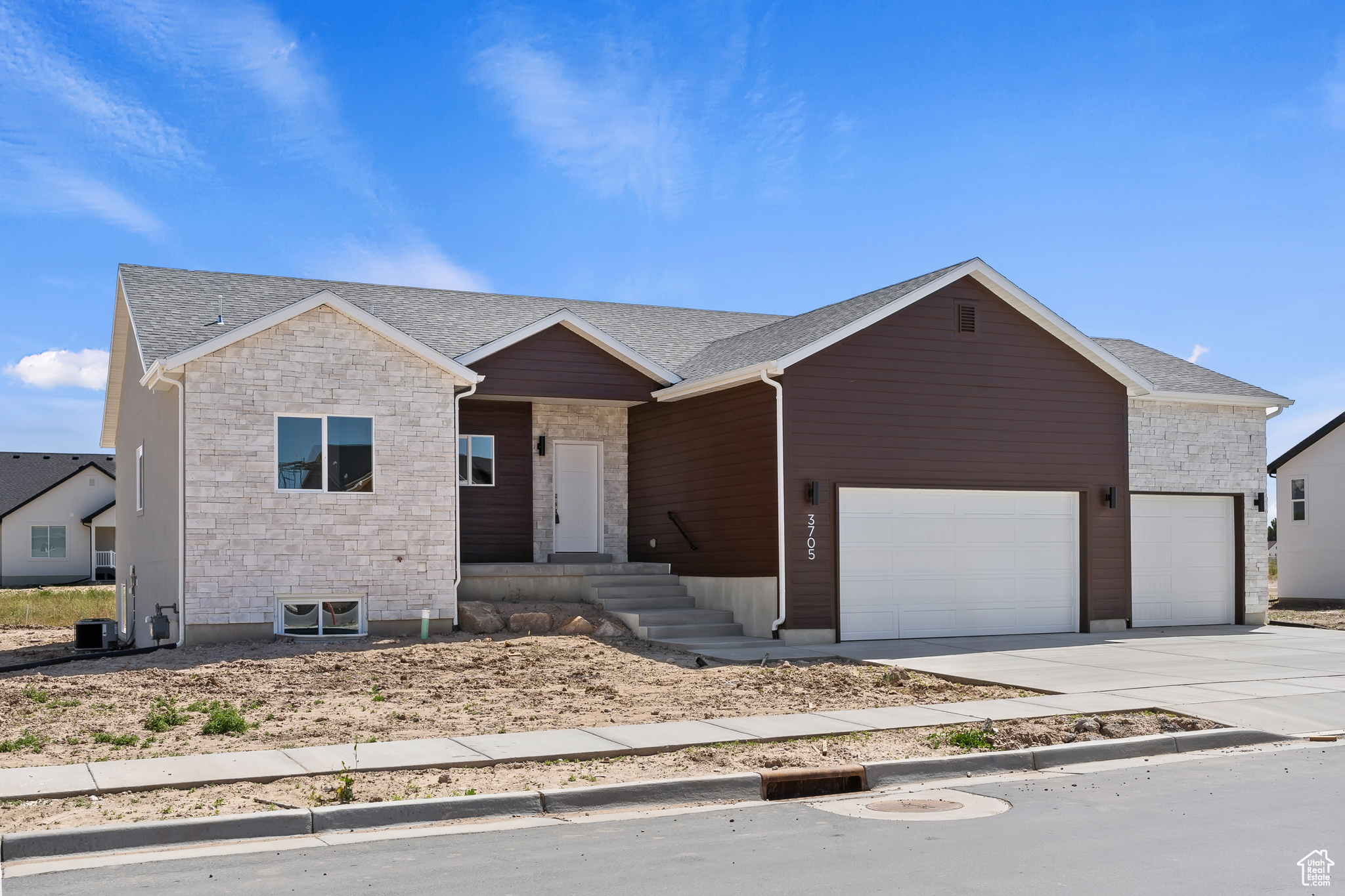 Ranch-style home featuring a garage and central AC