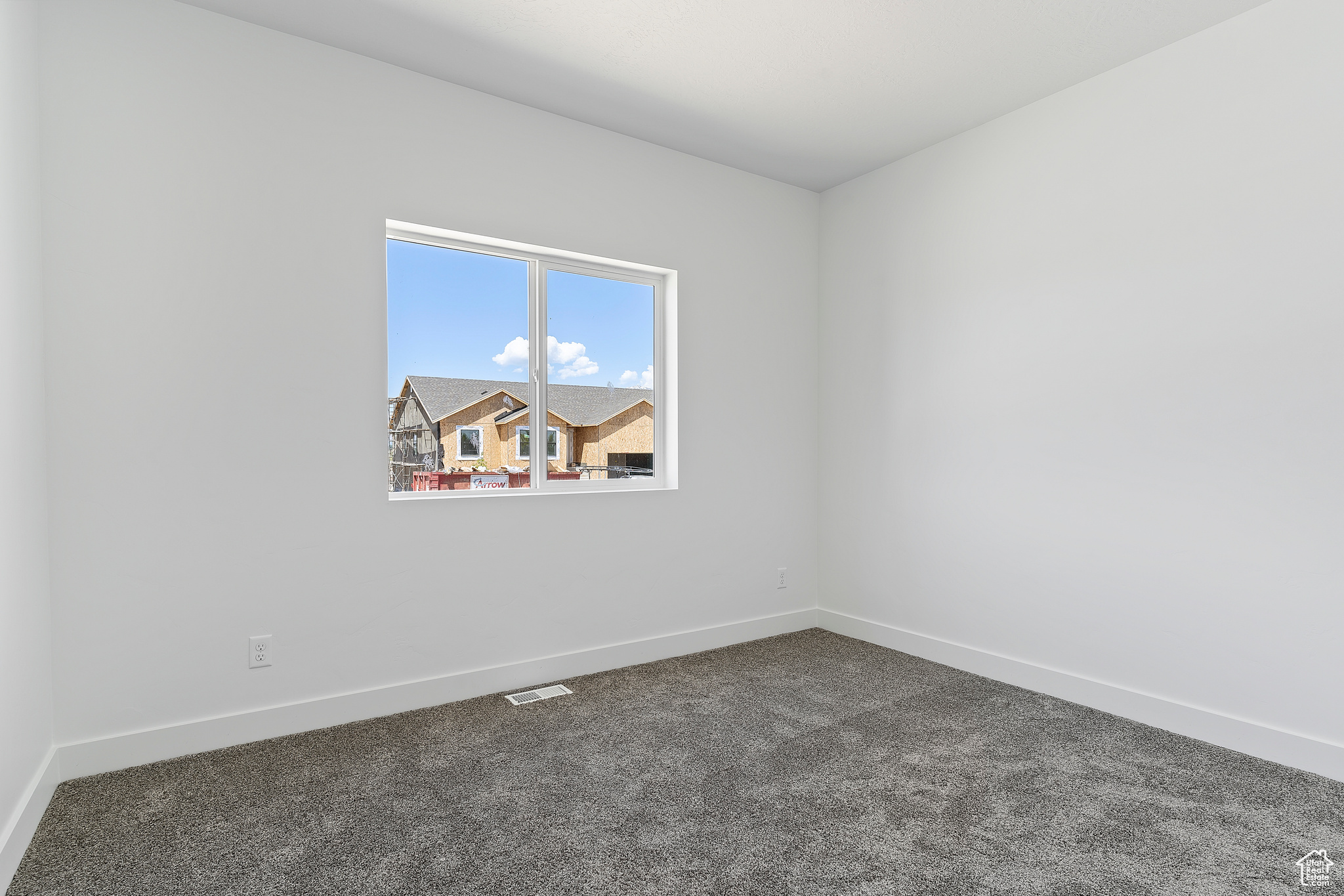 Spare room featuring carpet