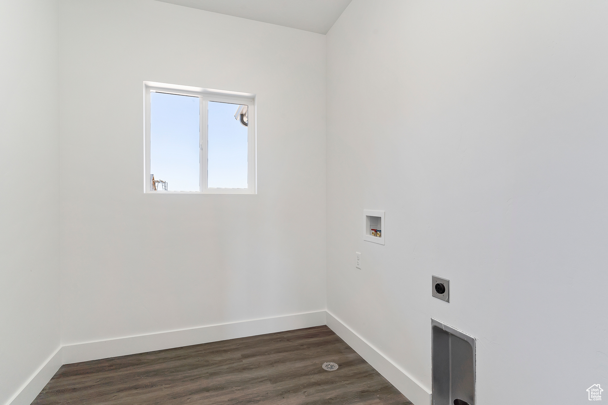 Laundry room with dark hardwood / wood-style floors, hookup for a washing machine, and hookup for an electric dryer