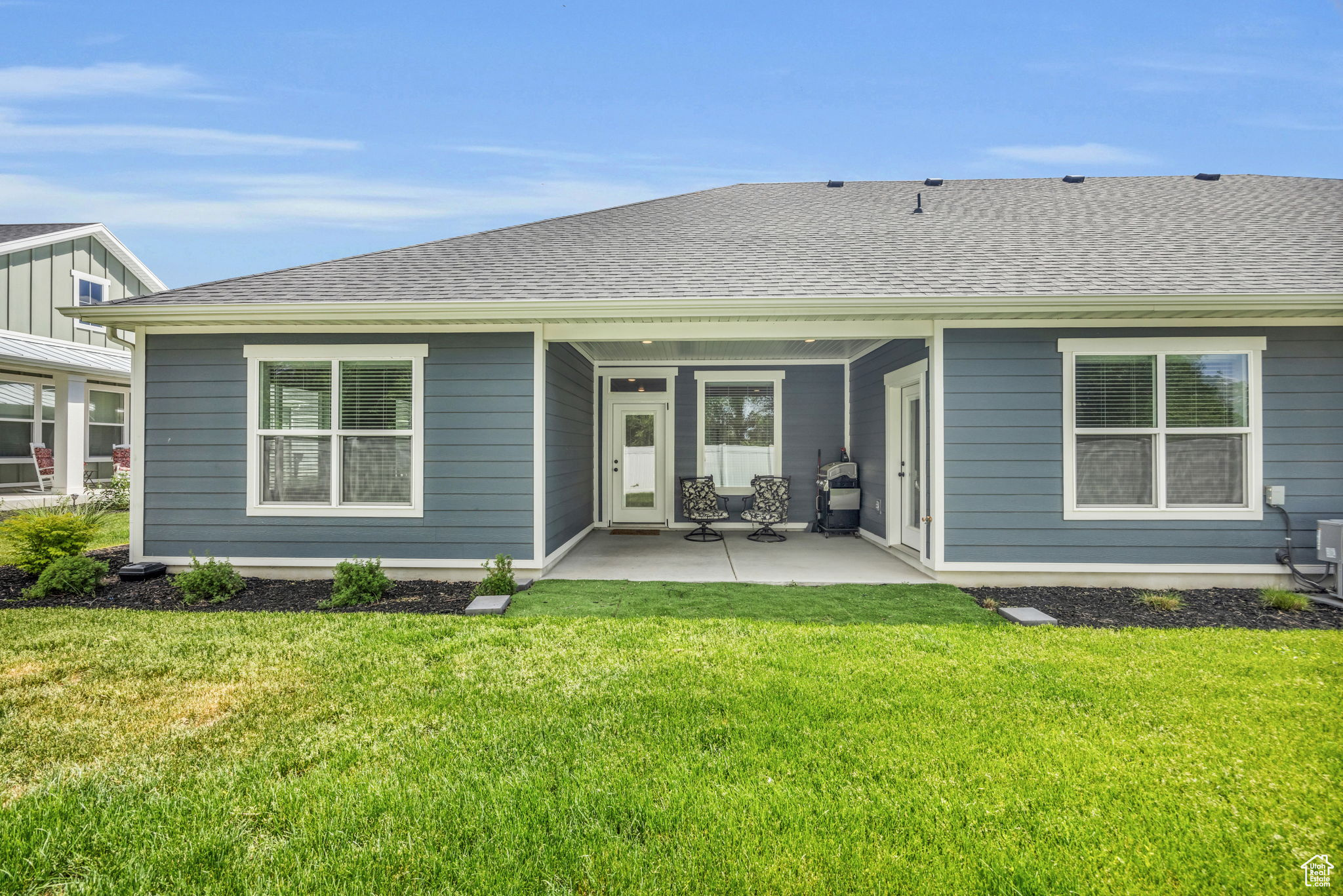 Rear view of property with a patio area and a yard