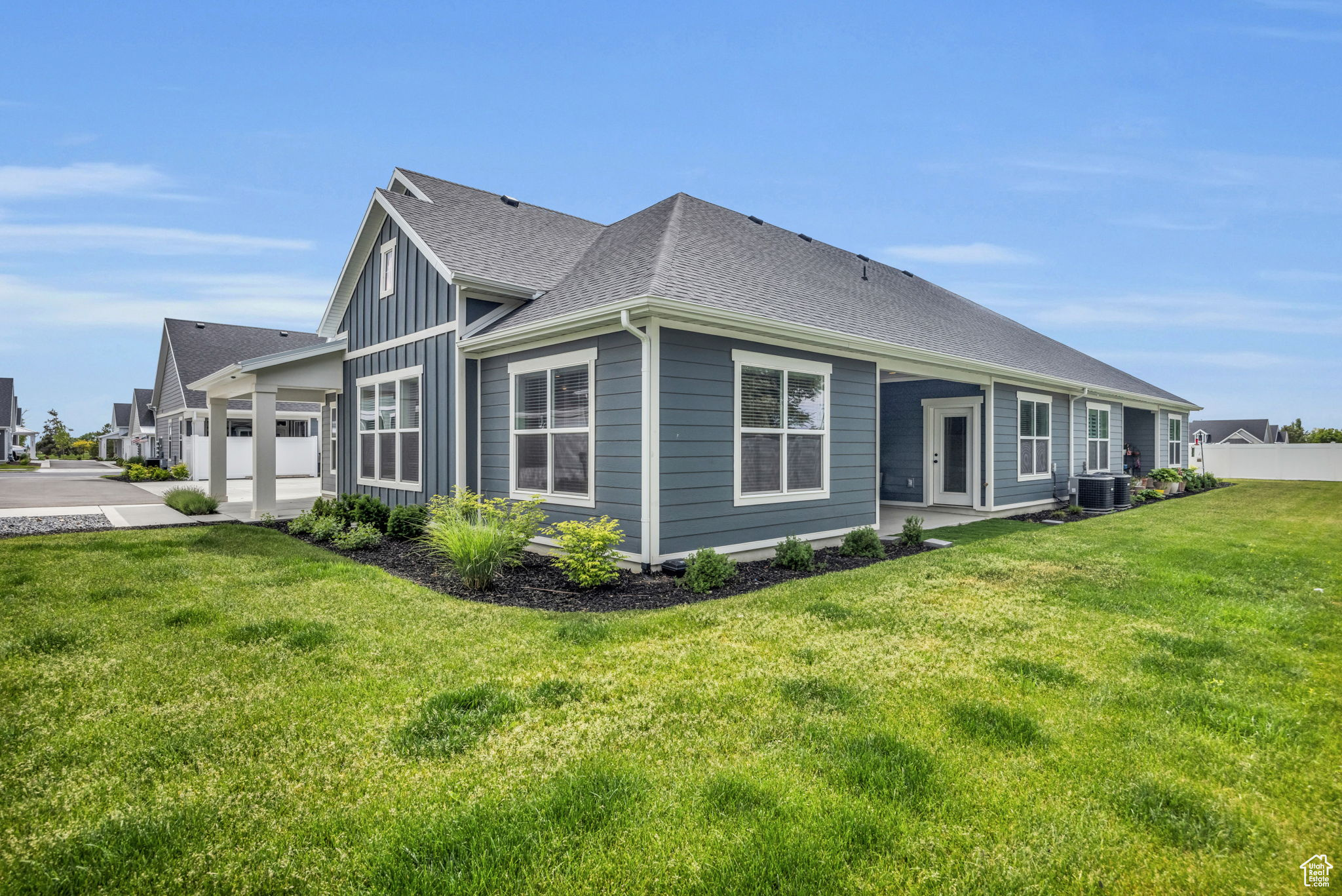 View of home's exterior with a garage, a yard, and central AC unit