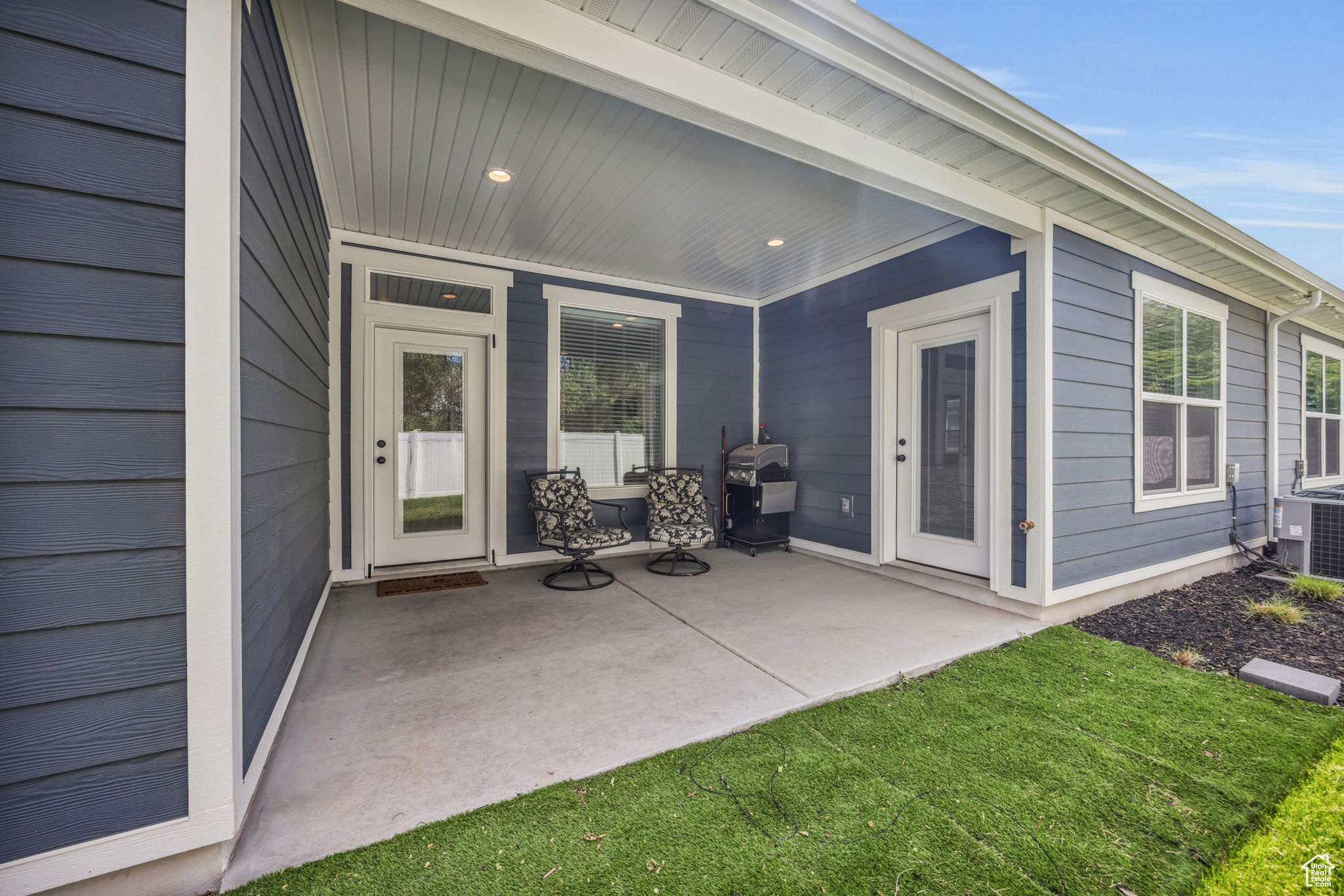 Exterior space with a porch, central air condition unit, and grilling area