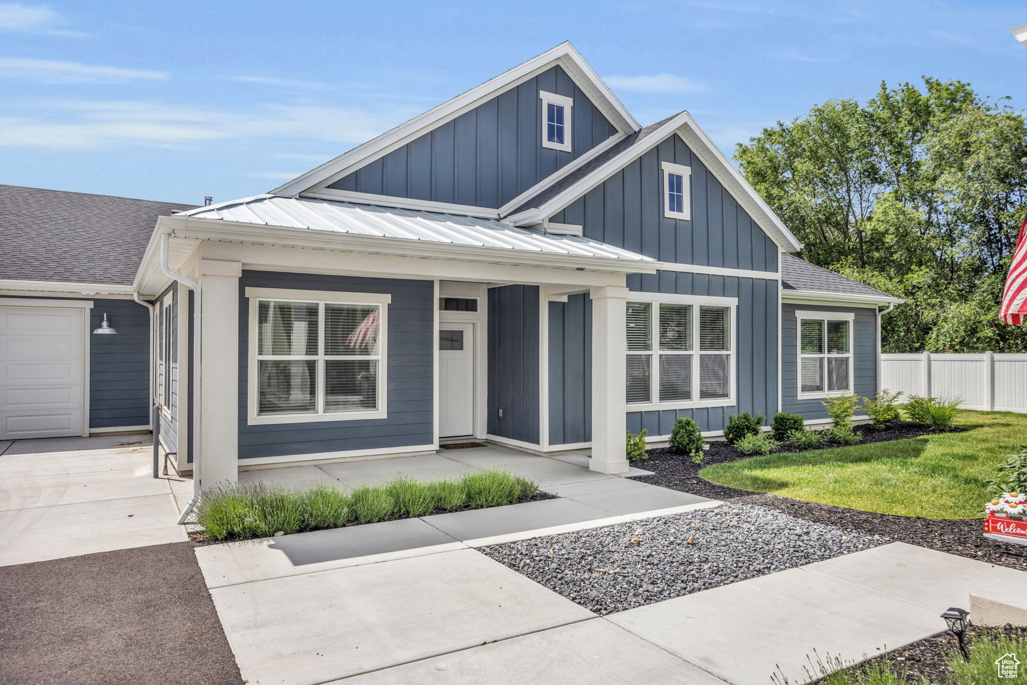 View of front of house with a garage and a front lawn