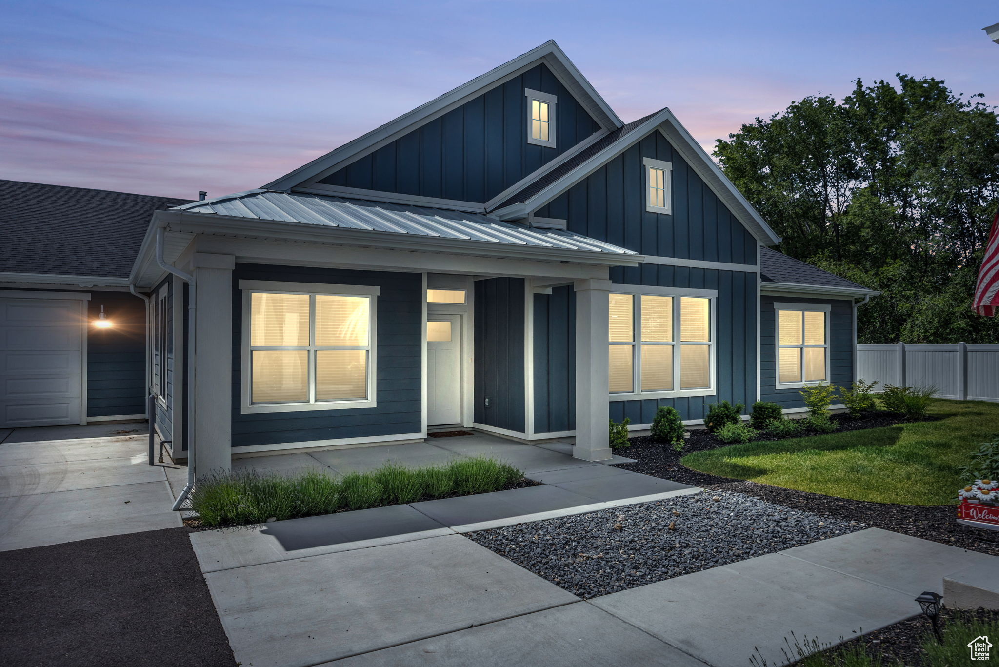 View of front of home with a garage and a yard