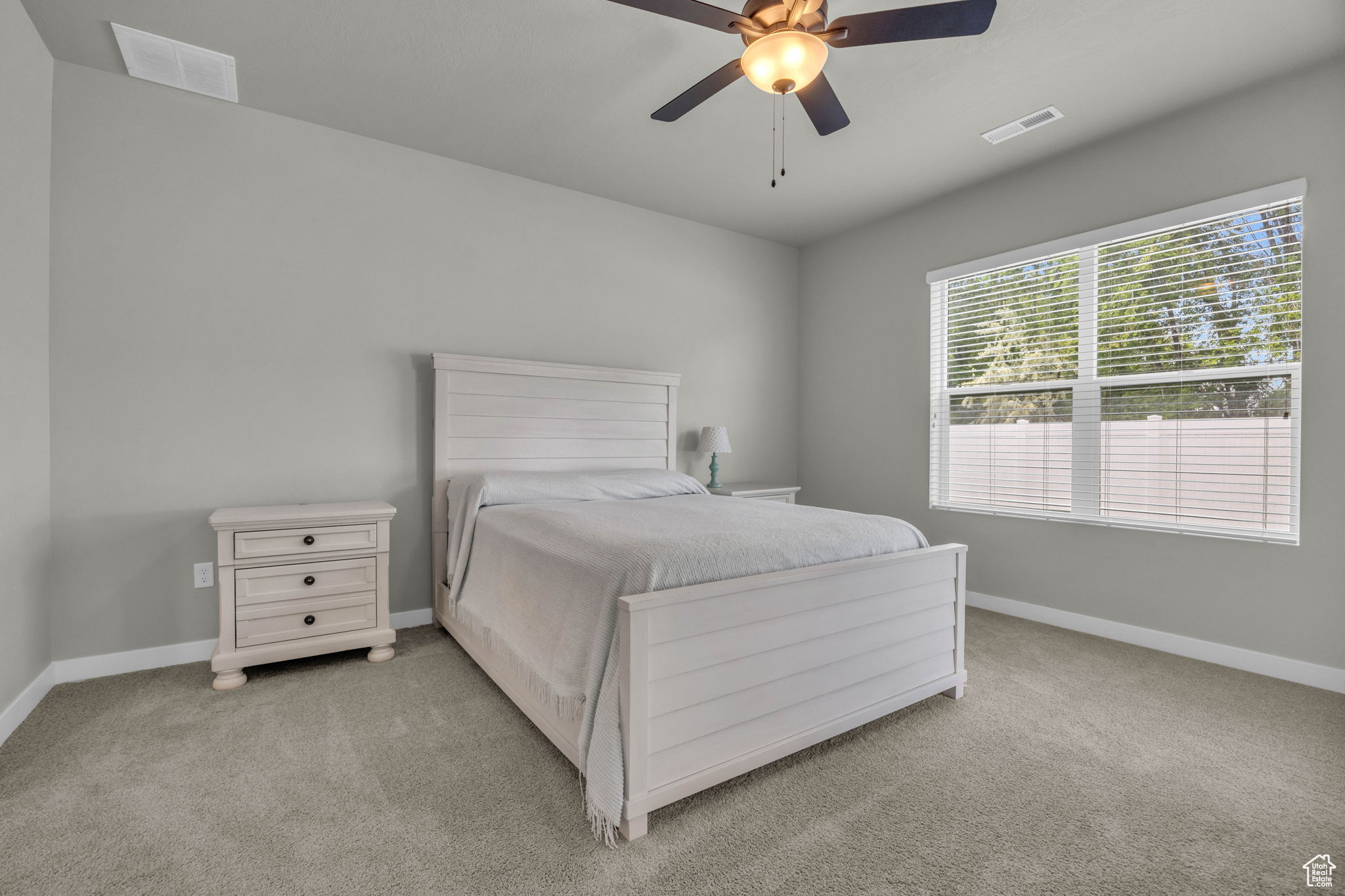 Bedroom featuring ceiling fan and light colored carpet