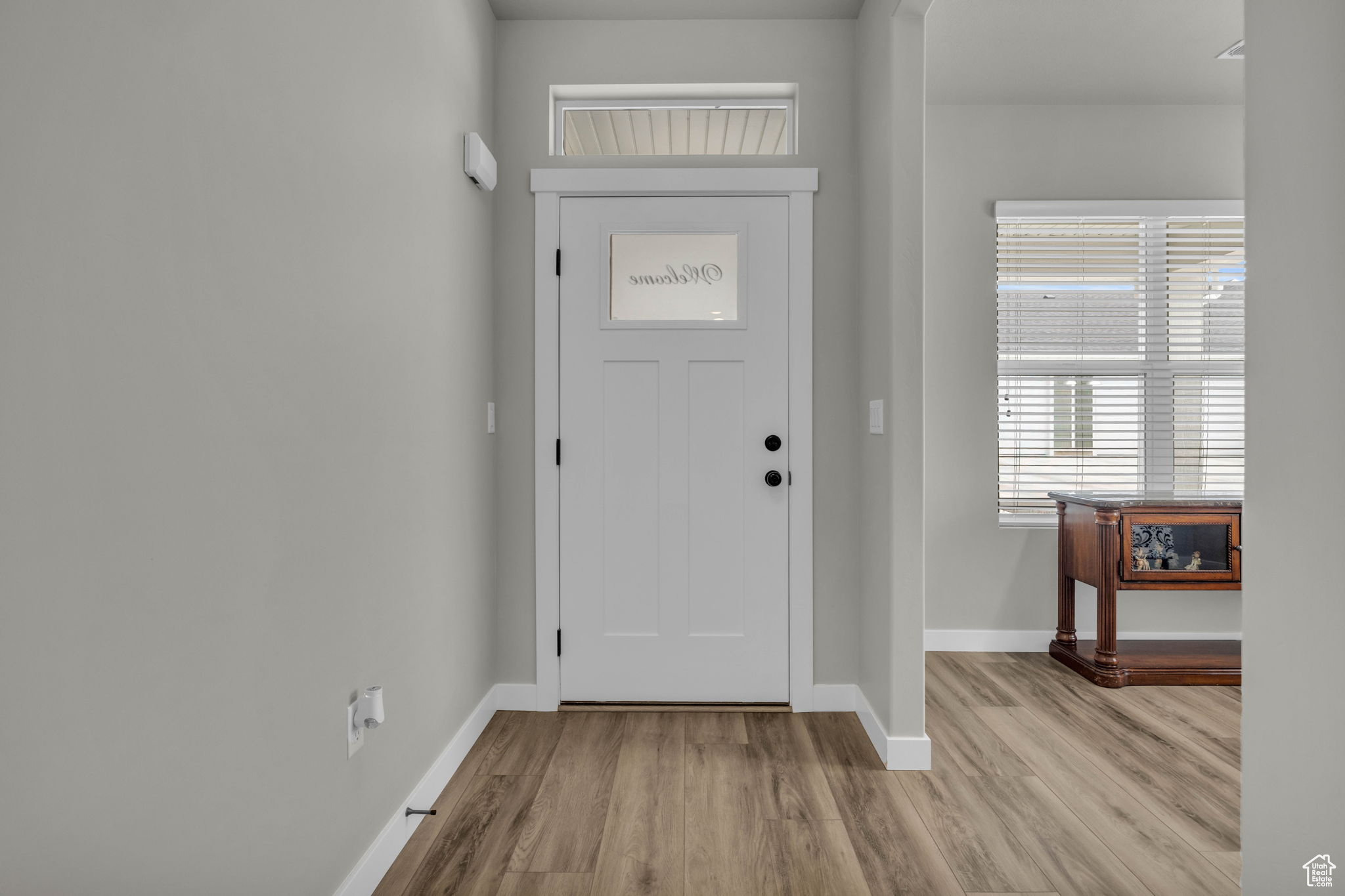 Entrance foyer with light wood-type flooring