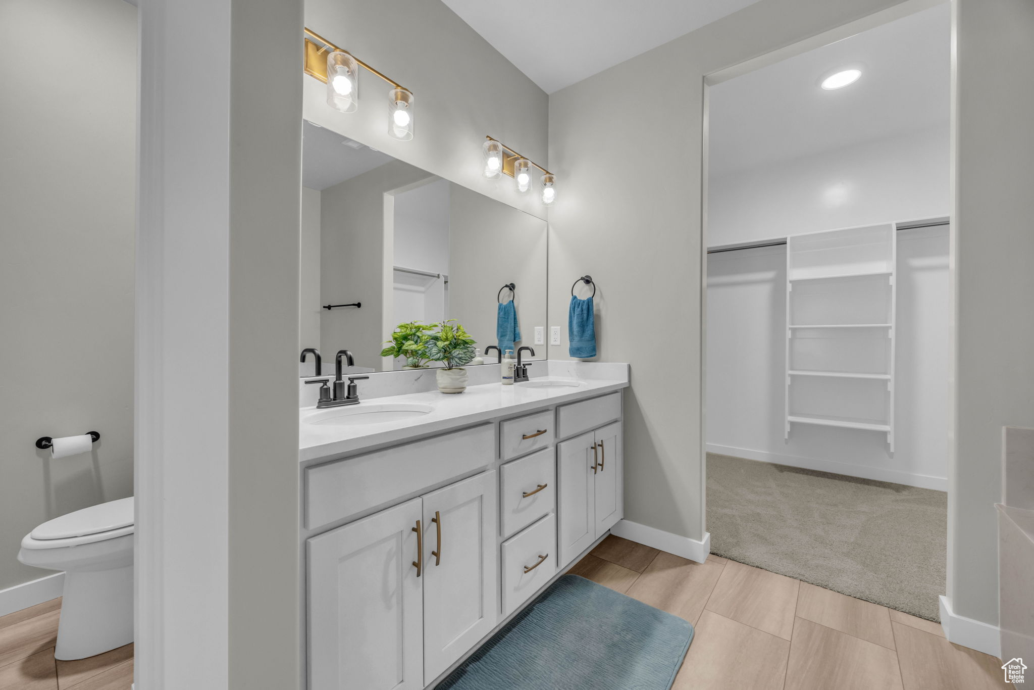 Bathroom featuring double vanity and toilet