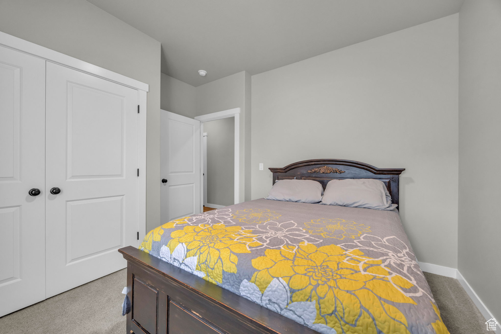 Bedroom featuring carpet and a closet