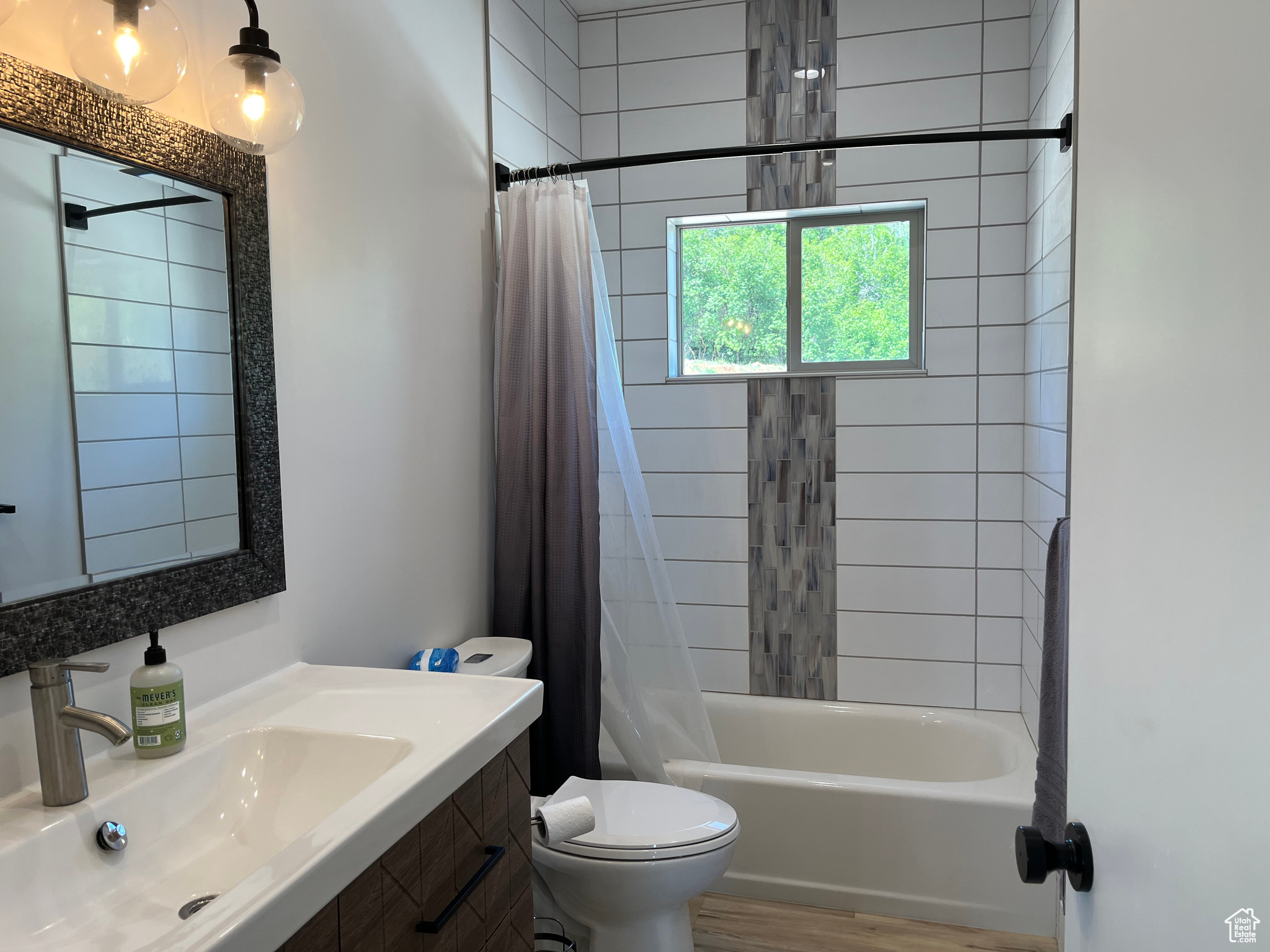 Upstairs 2nd Full bathroom with hardwood / wood-style floors, vanity, toilet, and shower / tub combo with curtain