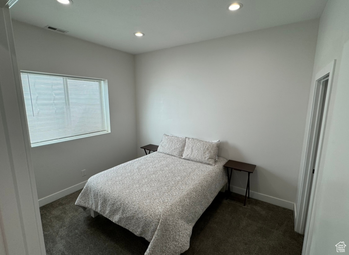 Bedroom with dark carpet