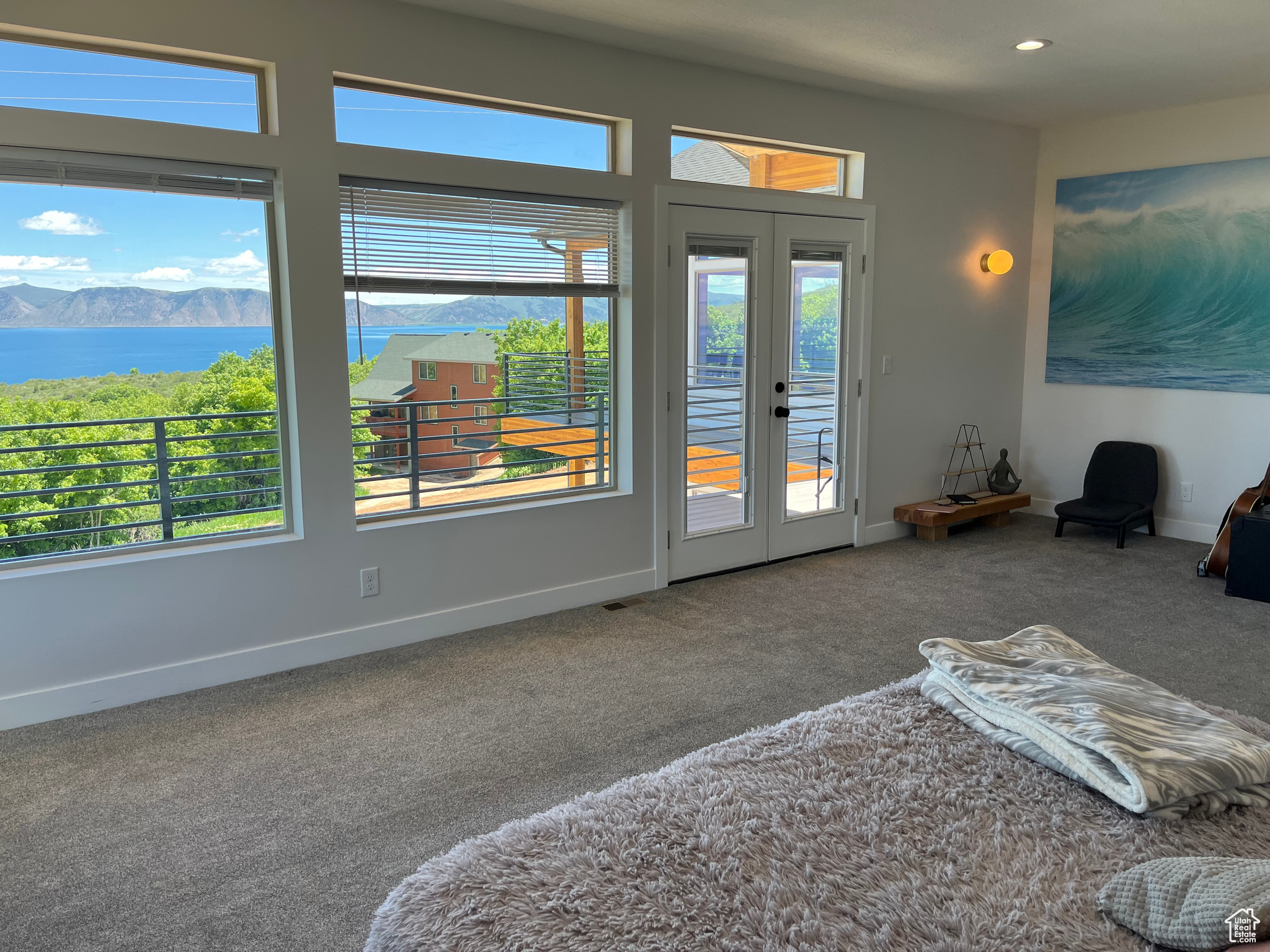 Master Suite featuring access to outside, french doors, carpet flooring, and multiple windows