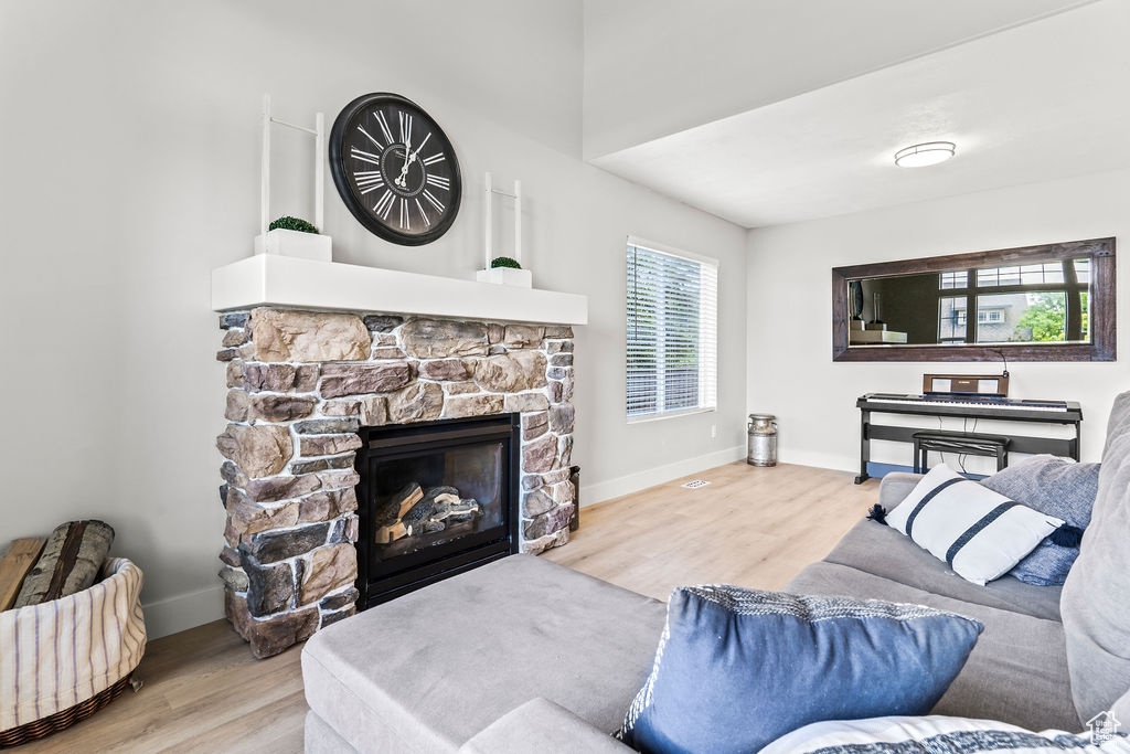 Front Entry Living room with a stone fireplace