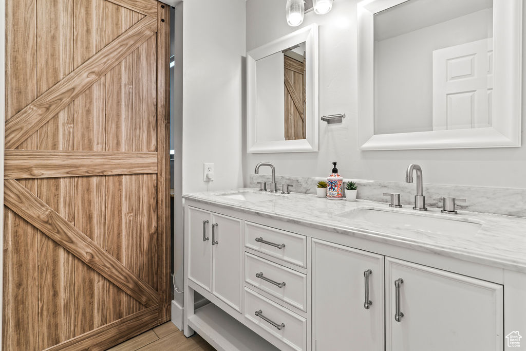 Bathroom Downstairs with double sink vanity, custom tile, Barn Door to the Shower Tub & Toilet