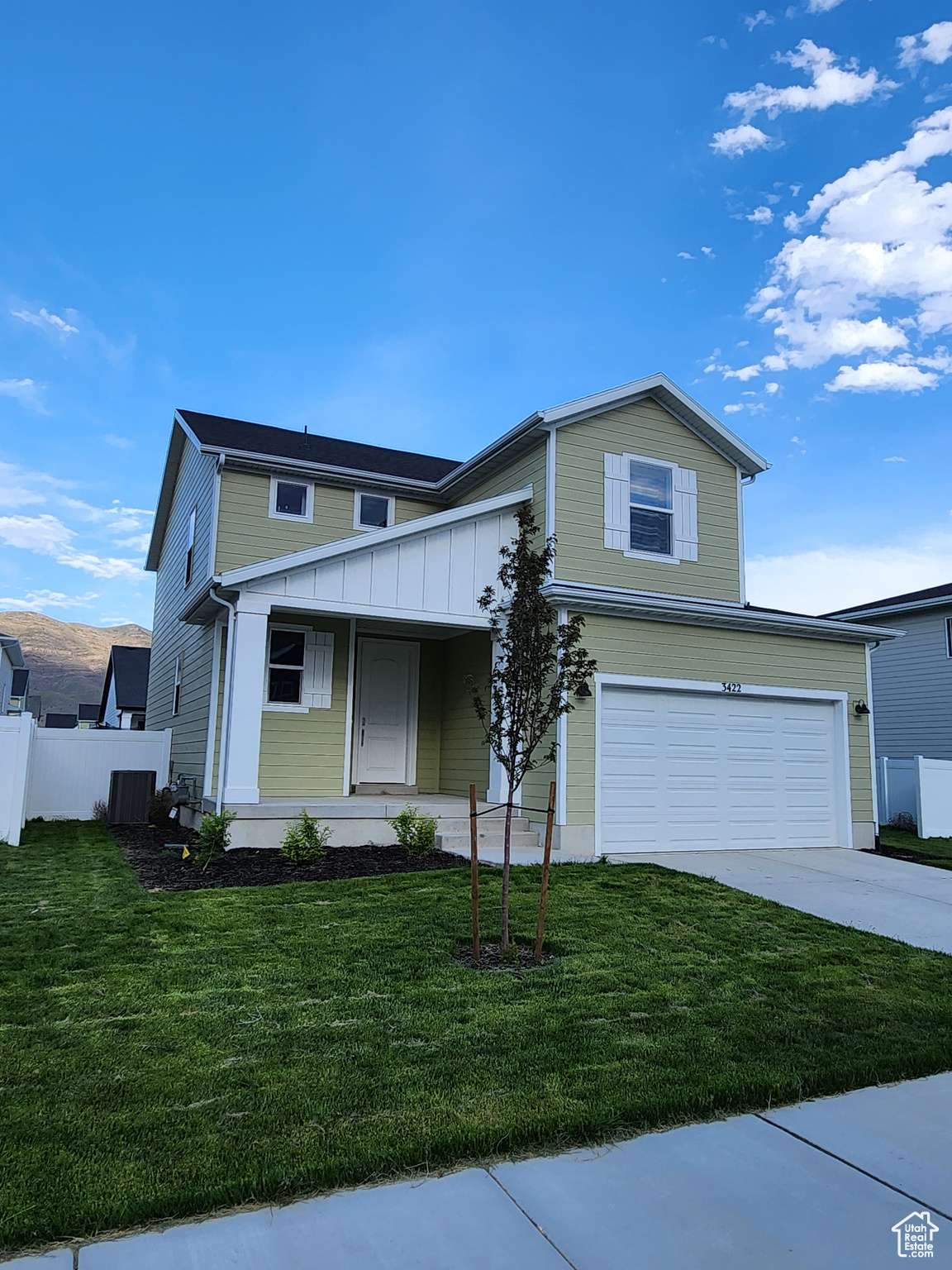 Front facade featuring a garage and a front lawn