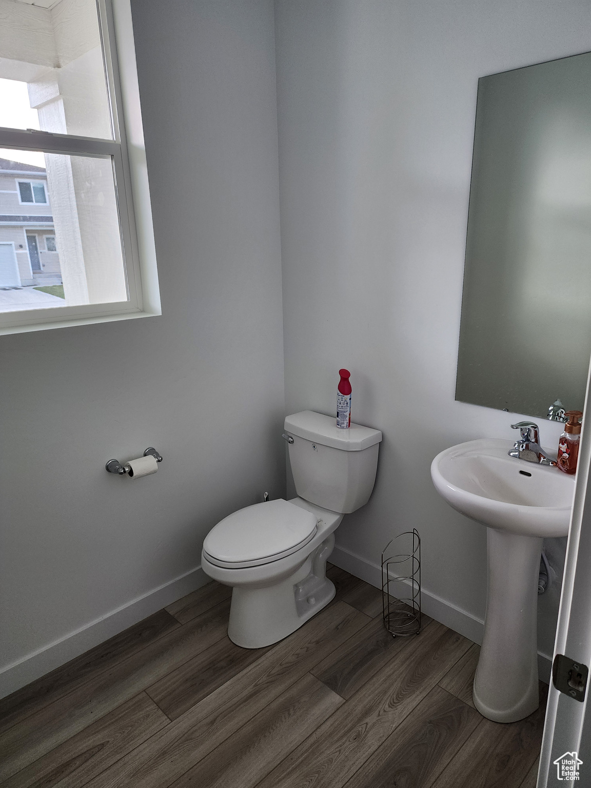 Bathroom with wood-type flooring and toilet