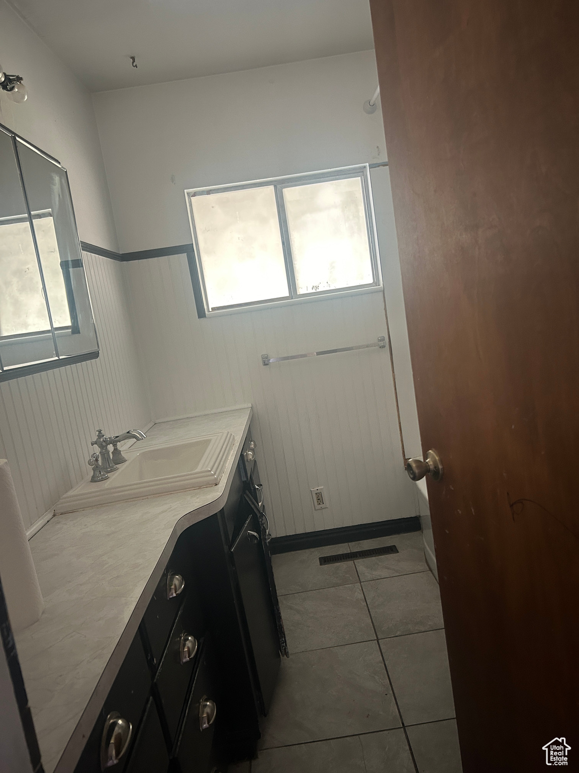 Bathroom featuring plenty of natural light, vanity, and tile patterned floors