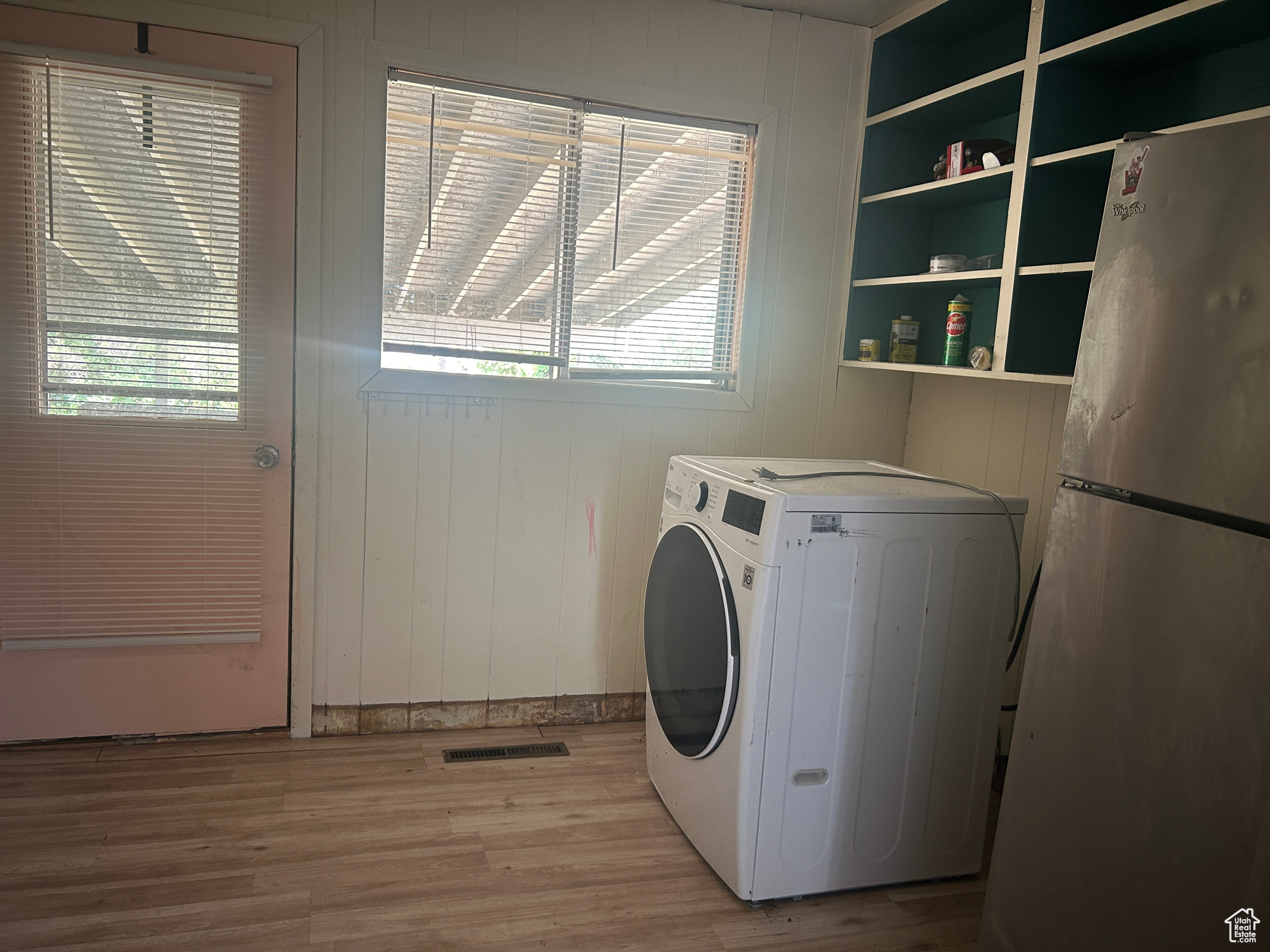 Laundry room with washer / clothes dryer and light hardwood / wood-style flooring