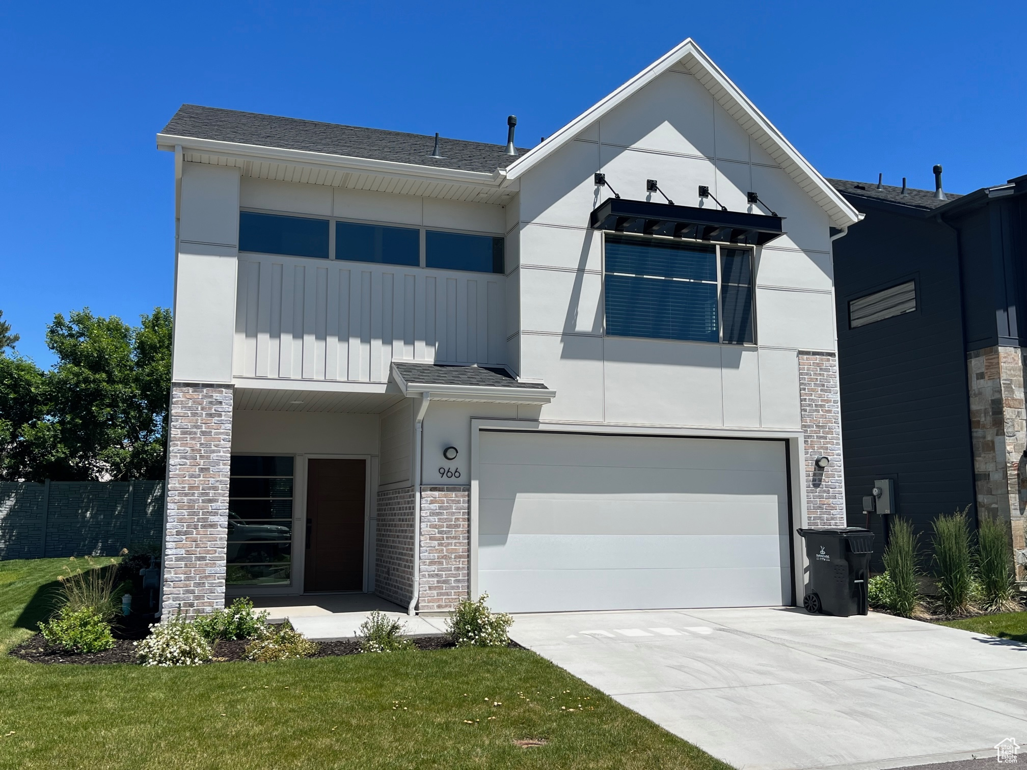 View of front facade featuring a front yard and a garage