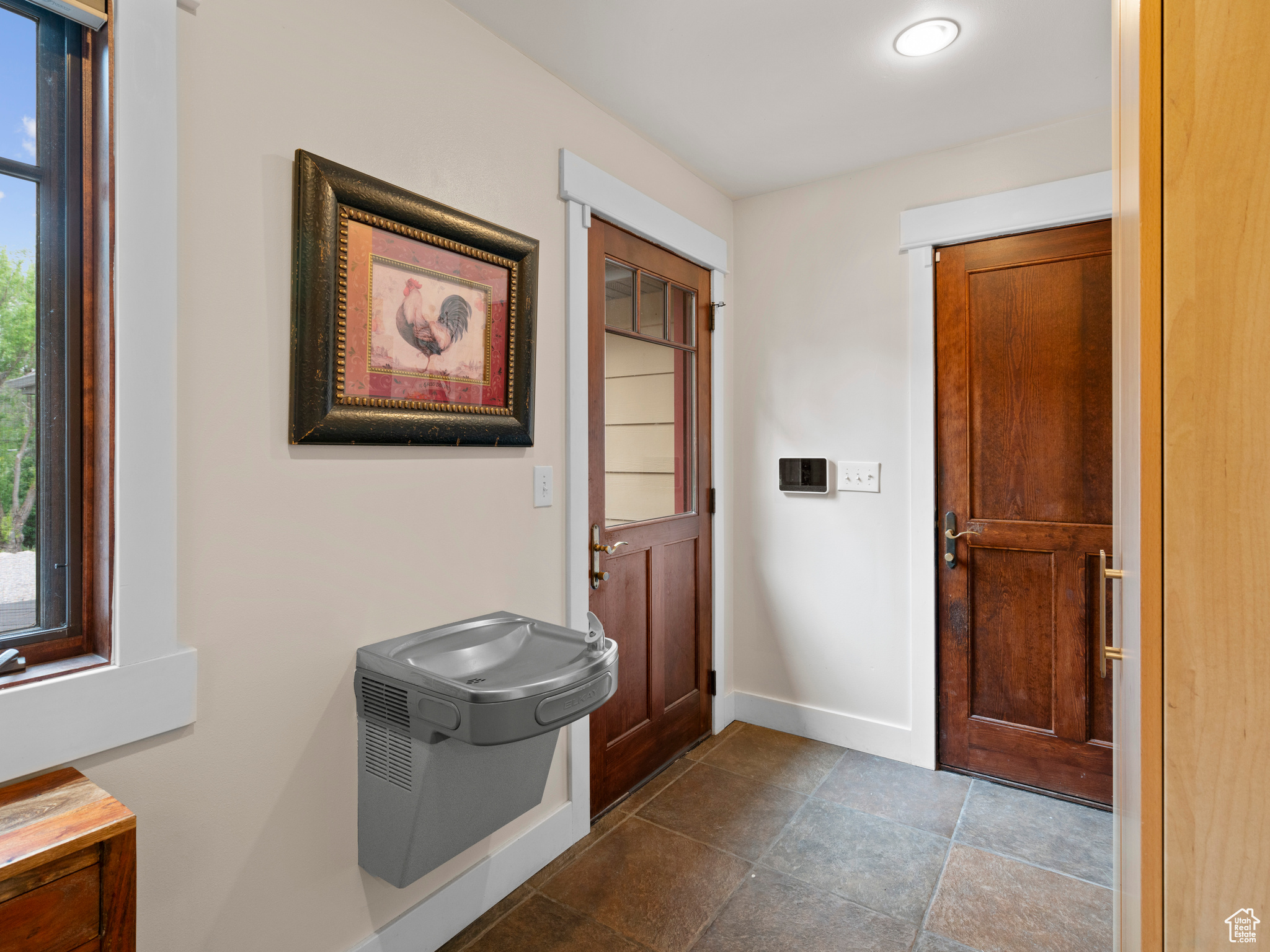 Mudroom with tile, half bath, and drinking fountain