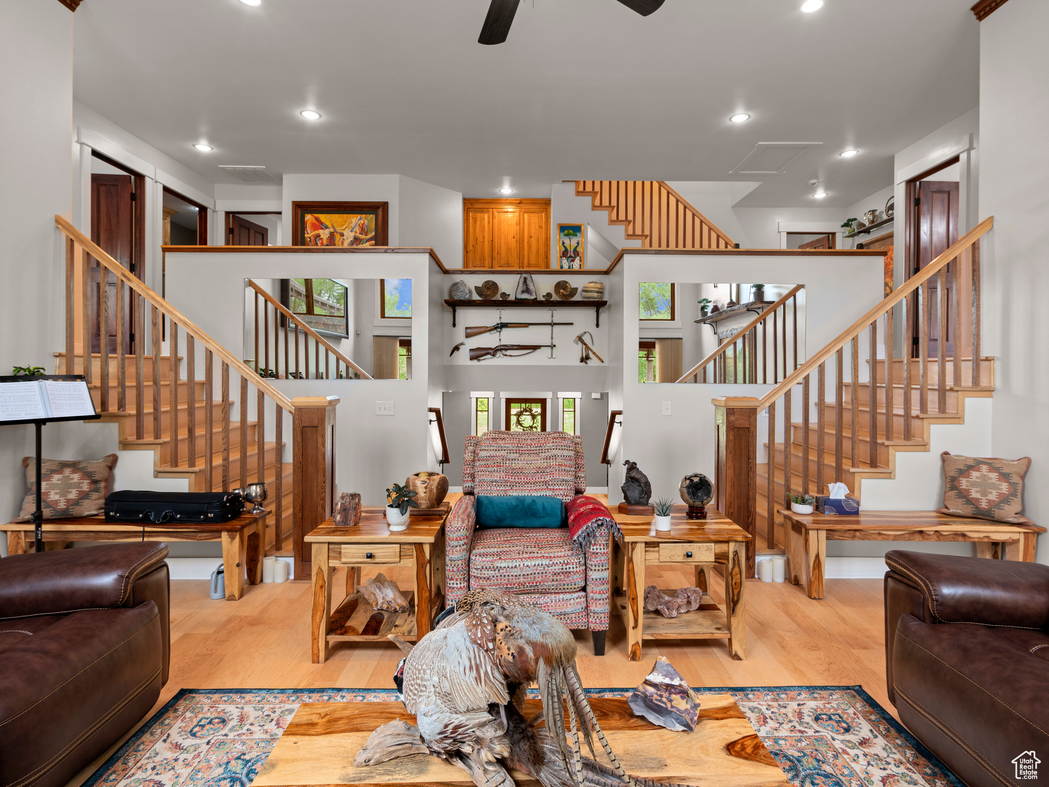 Living room with ceiling fan and hardwood flooring