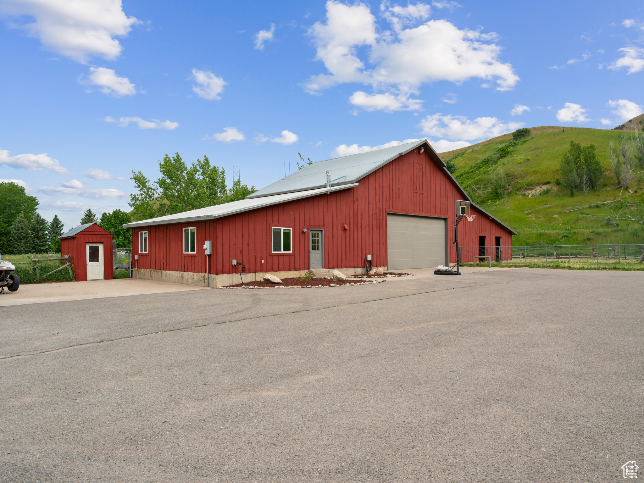 View of front facade with an outdoor structure, a mountain view, and a garage