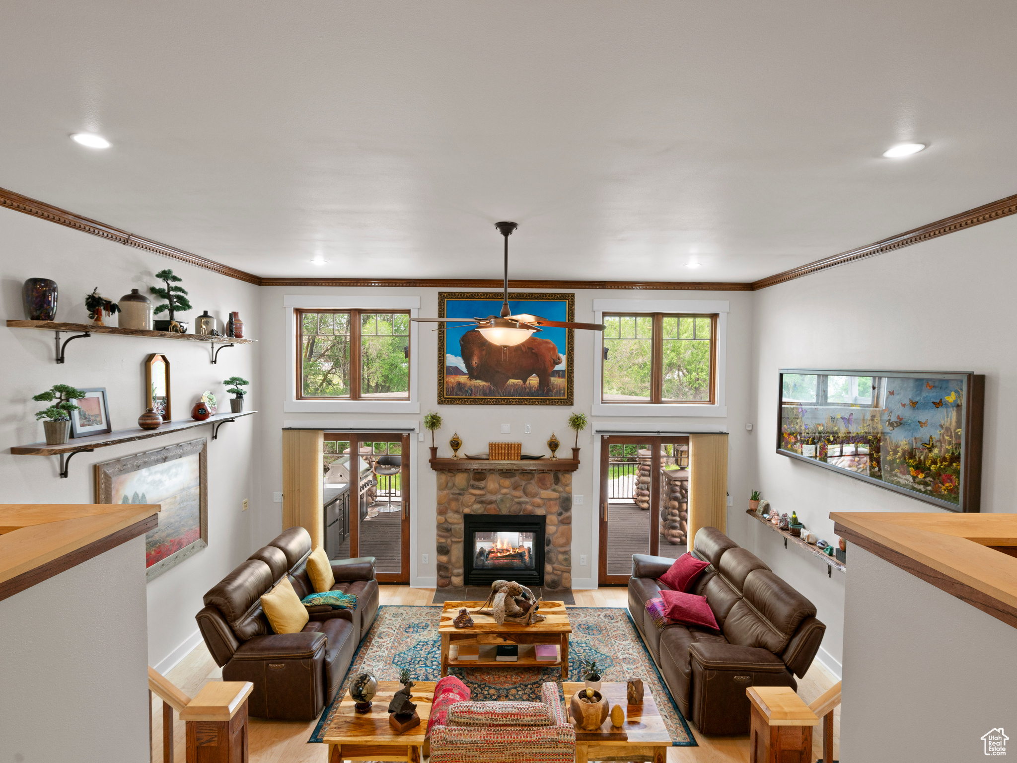 Living room featuring plenty of natural light, light hardwood floors, and a fireplace