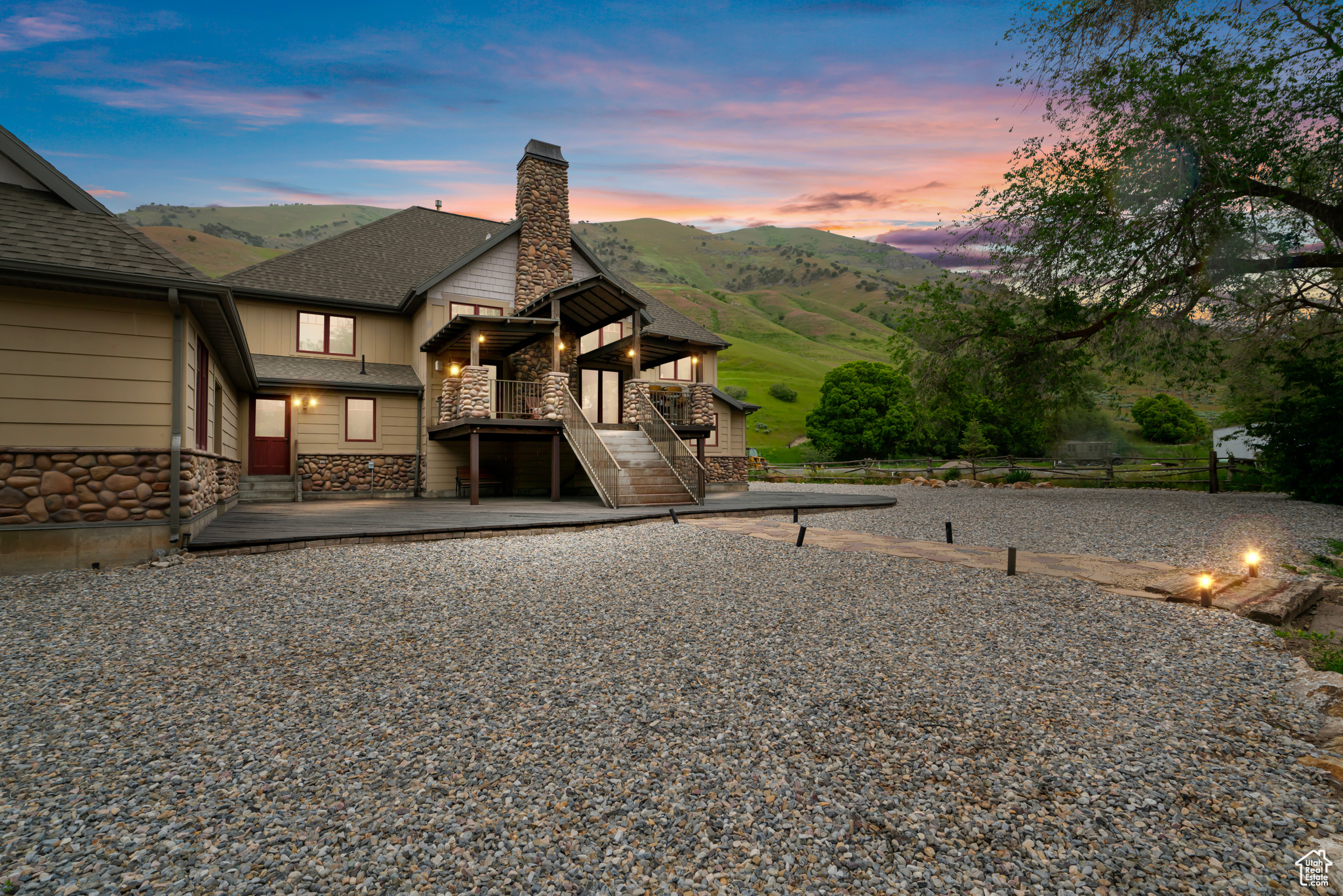 Back house at dusk featuring a patio area and a mountain view