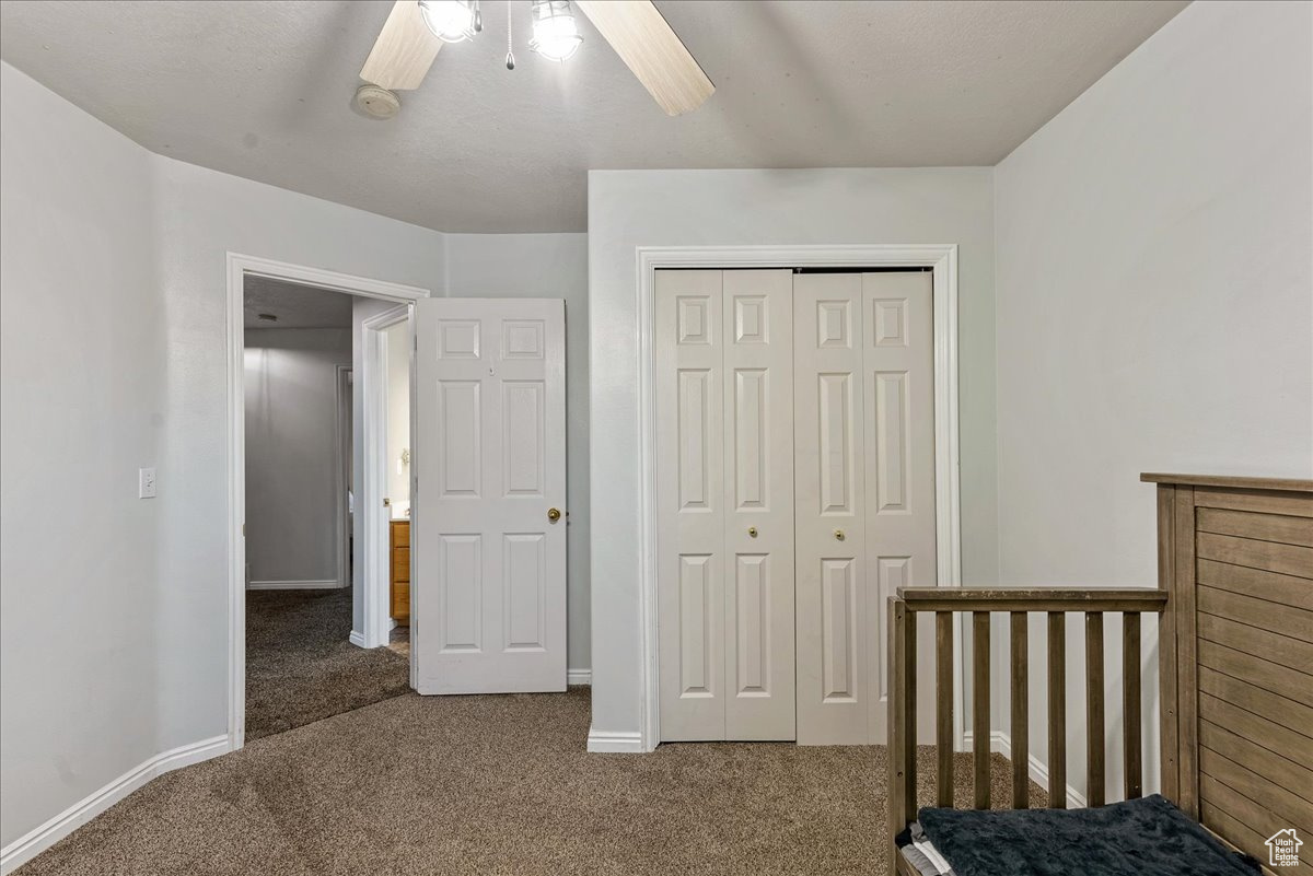 Bedroom featuring a closet, carpet, and ceiling fan